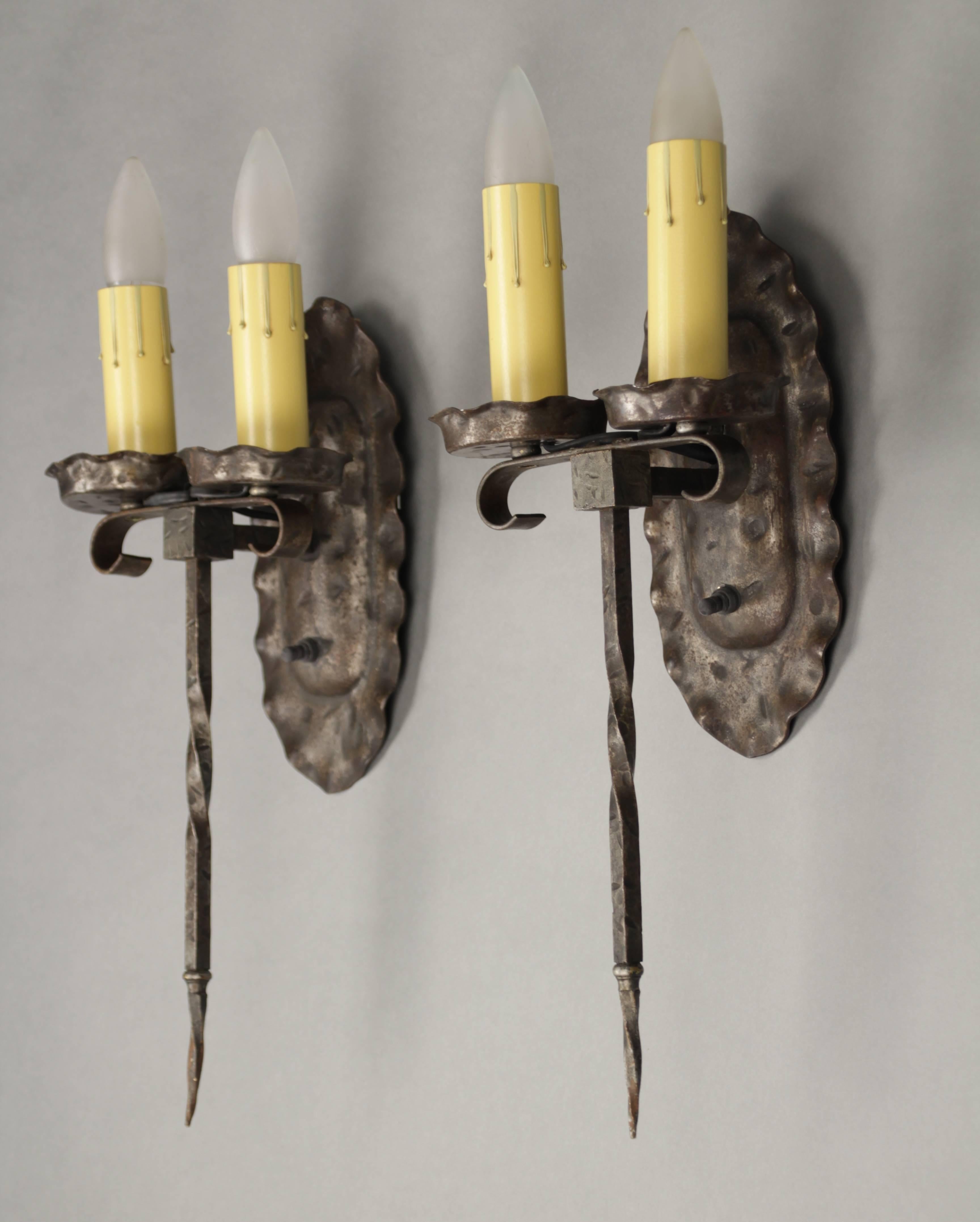Hard to find pair of medium size sconces. Wrought iron construction.