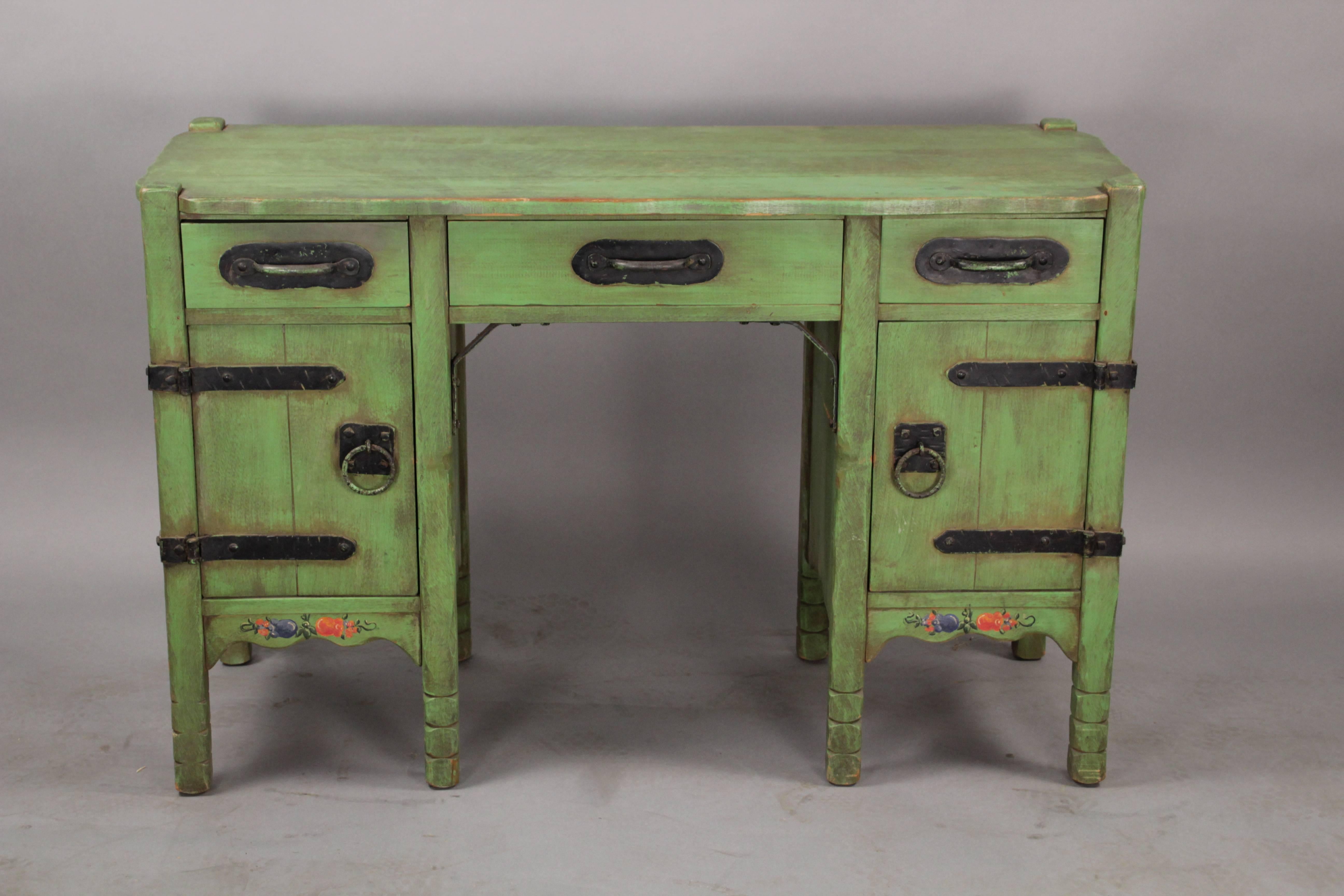 Early 1930s Monterey desk in Spanish green finish. The right door has iron shelves and the left door opens to two sliding drawers. Signed.