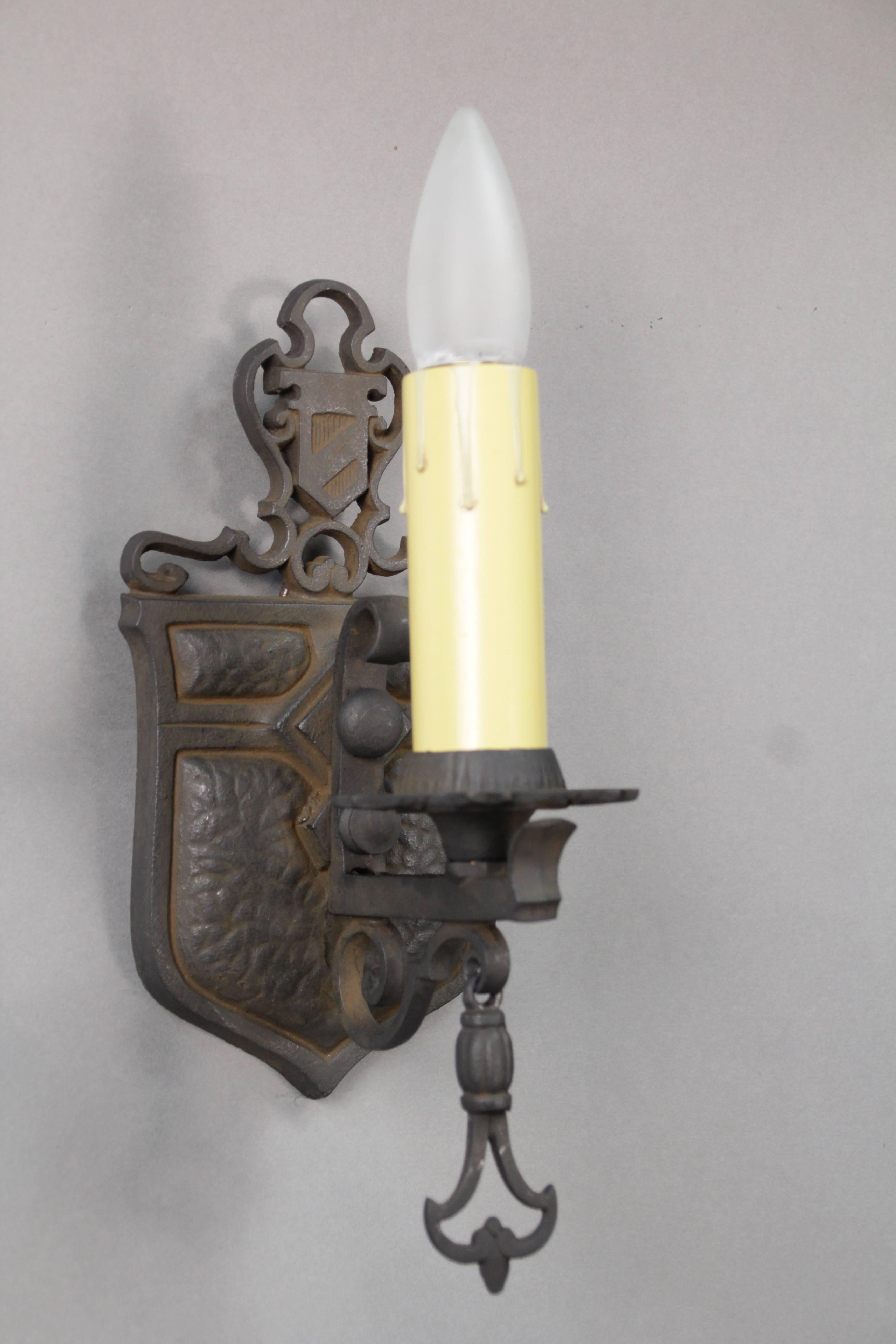 Spanish Revival single sconce with crest motif, circa 1920s.