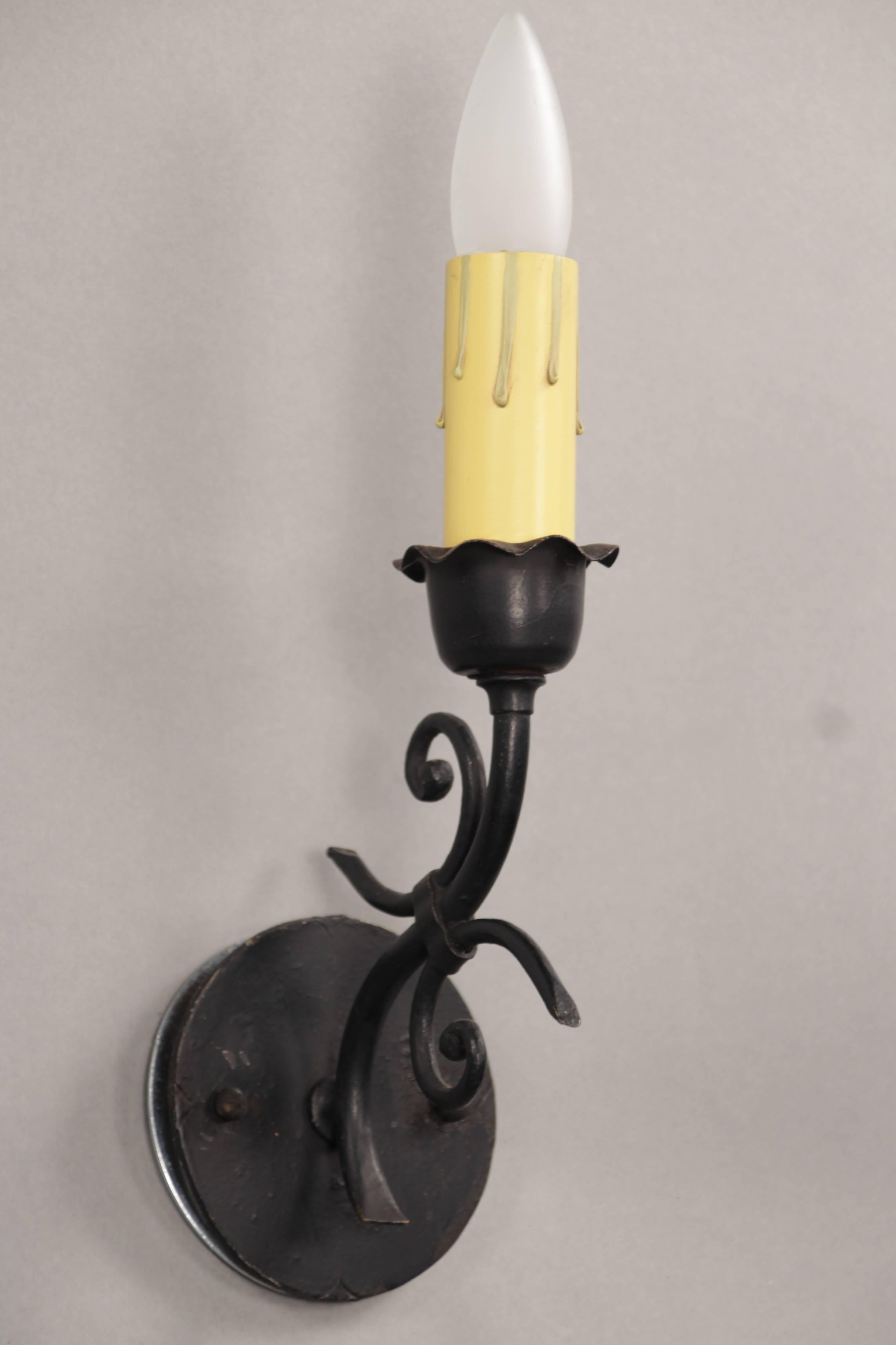 Simple wrought iron 1920s sconces with circular backplate.