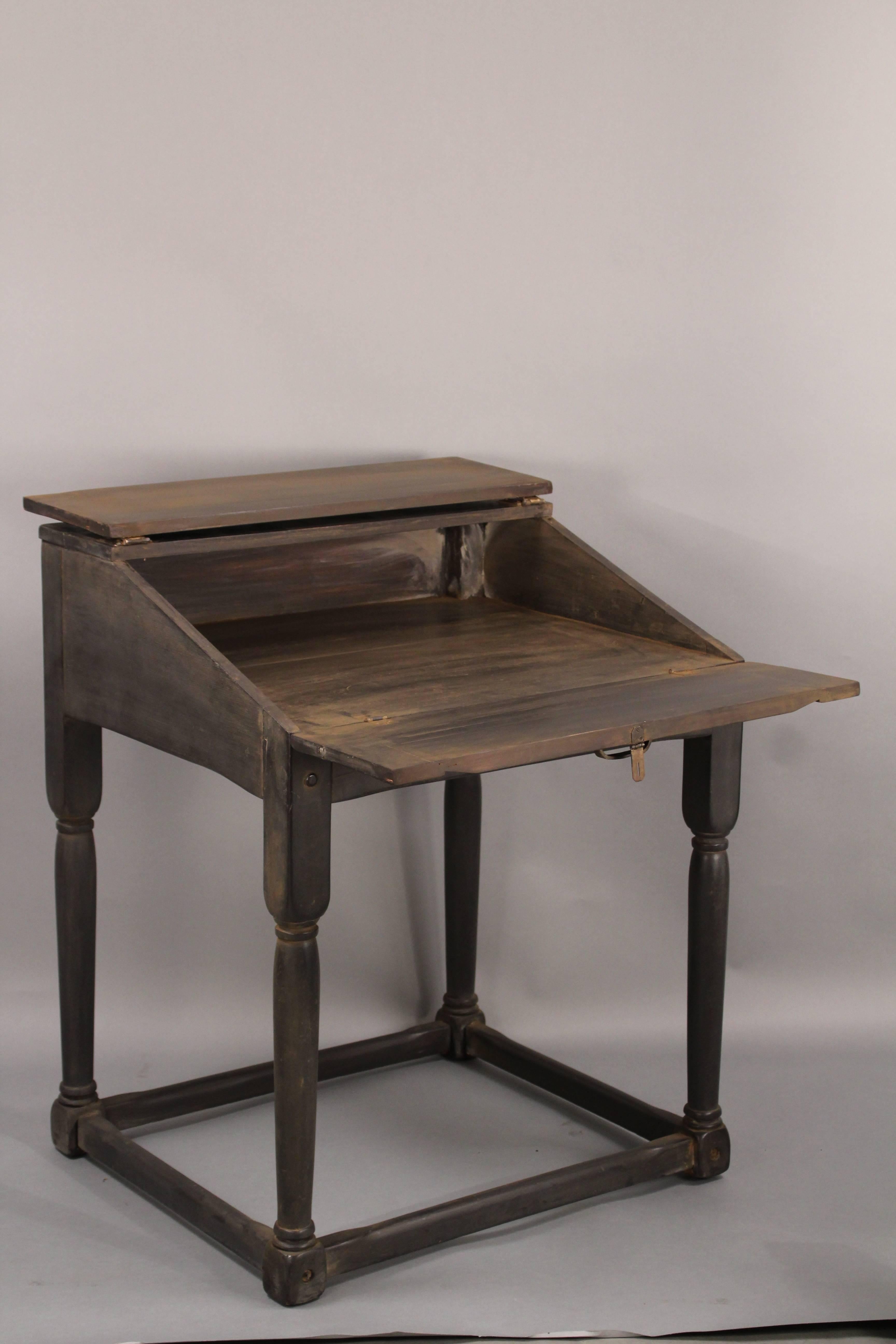 Desk with fold down desk top with original iron hardware. Restored finish. Measure: 37