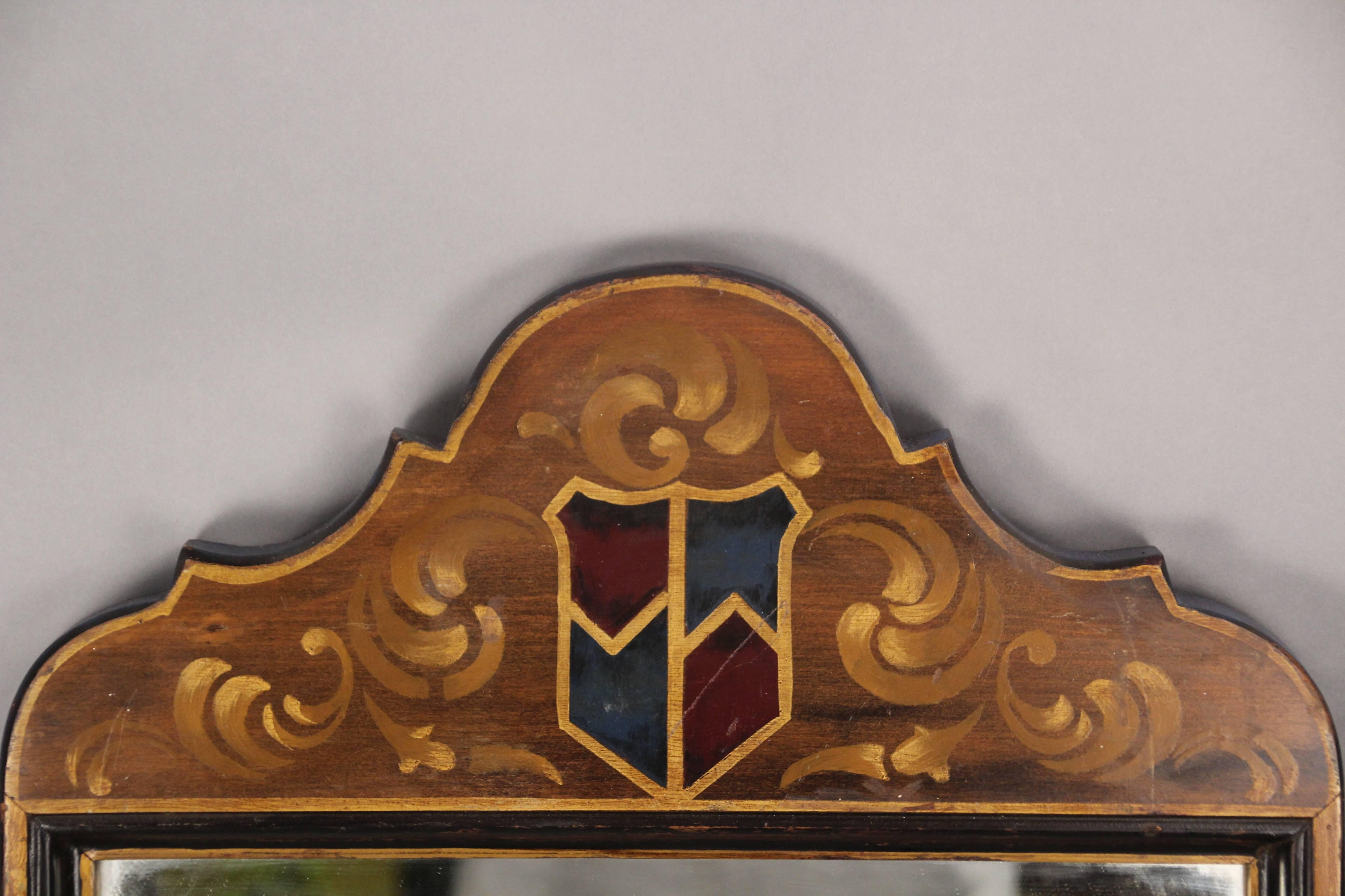 Tall mirror with hand-painted crest details, circa 1920s.