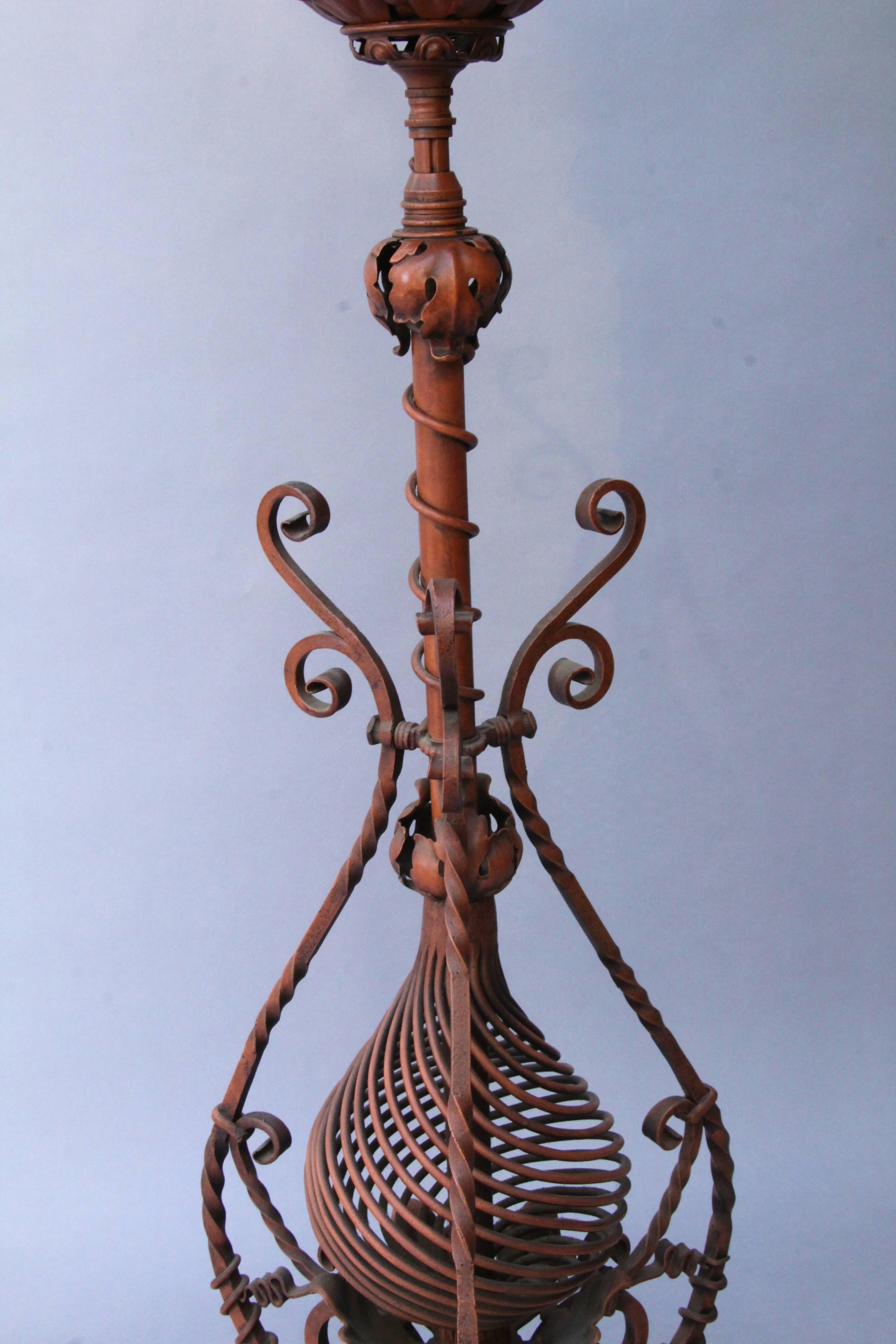 1920s floor lamp with exceptional ironwork. Originally an oil lamp, later converted to electric. Measures: 66