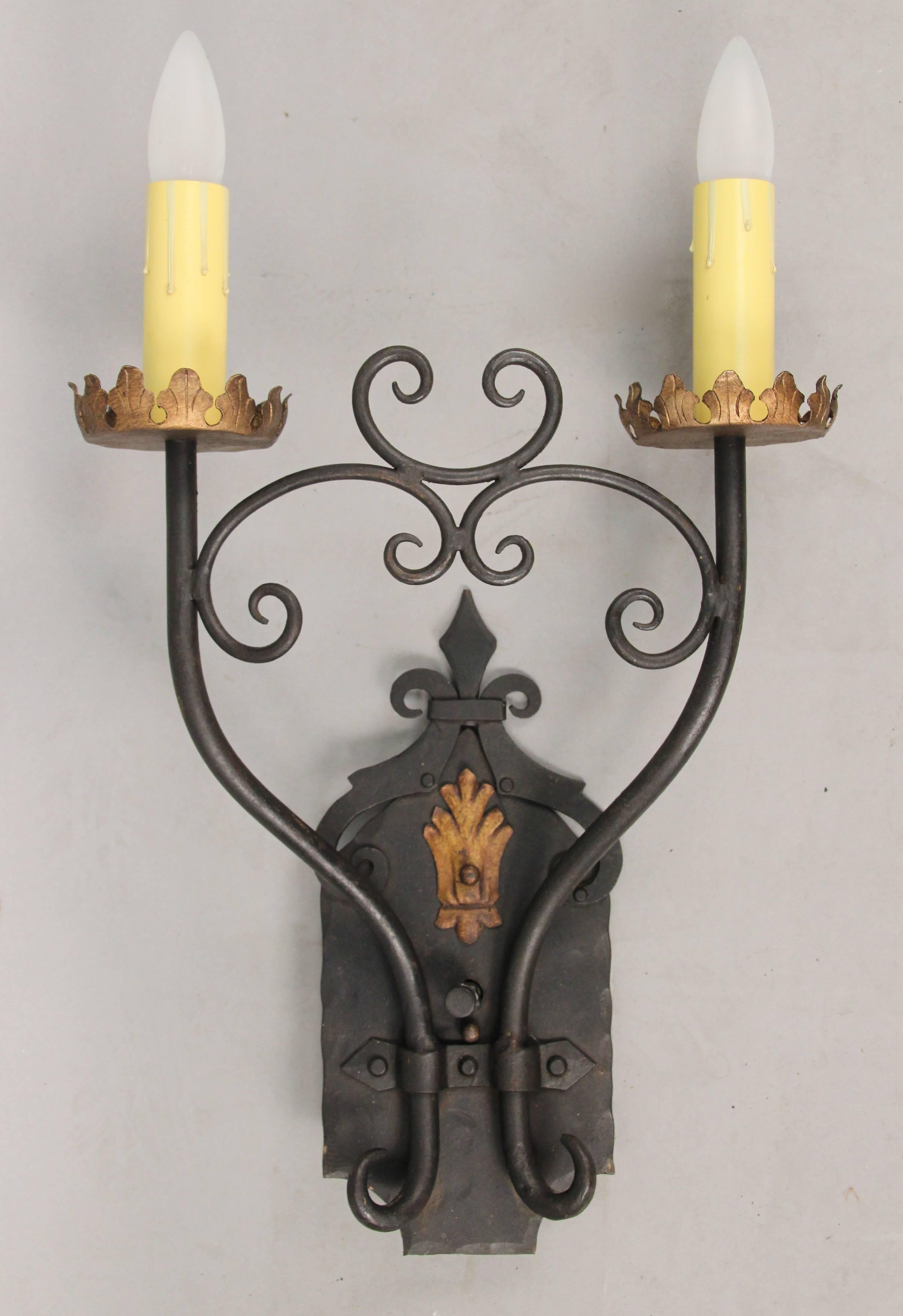 Beautiful and stately 1920s wrought iron two-light sconces. Hard to find high quality pair. Salvaged from local Los Angeles home.