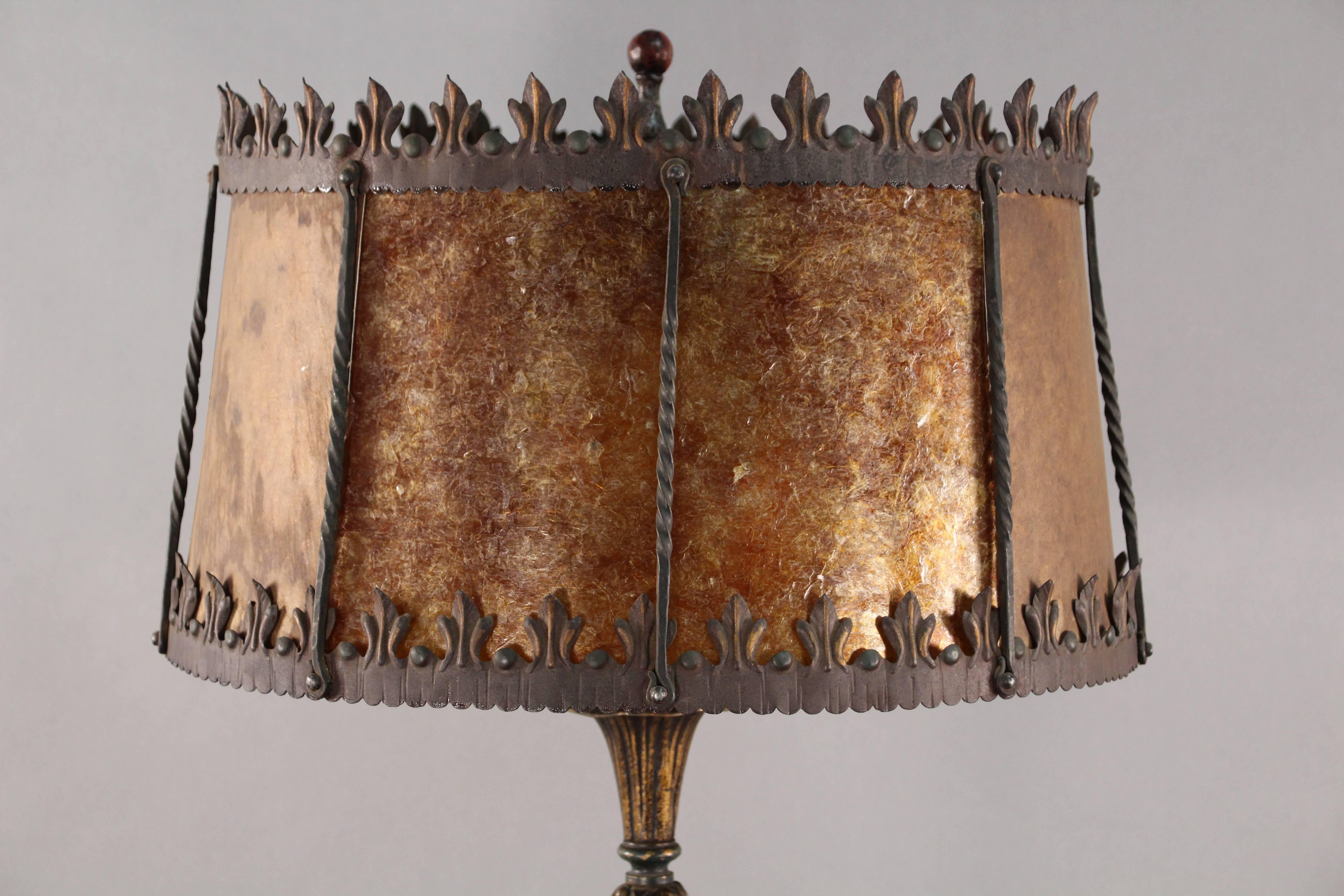 Beautiful 1920s floor lamp with mica shade and intricate base.