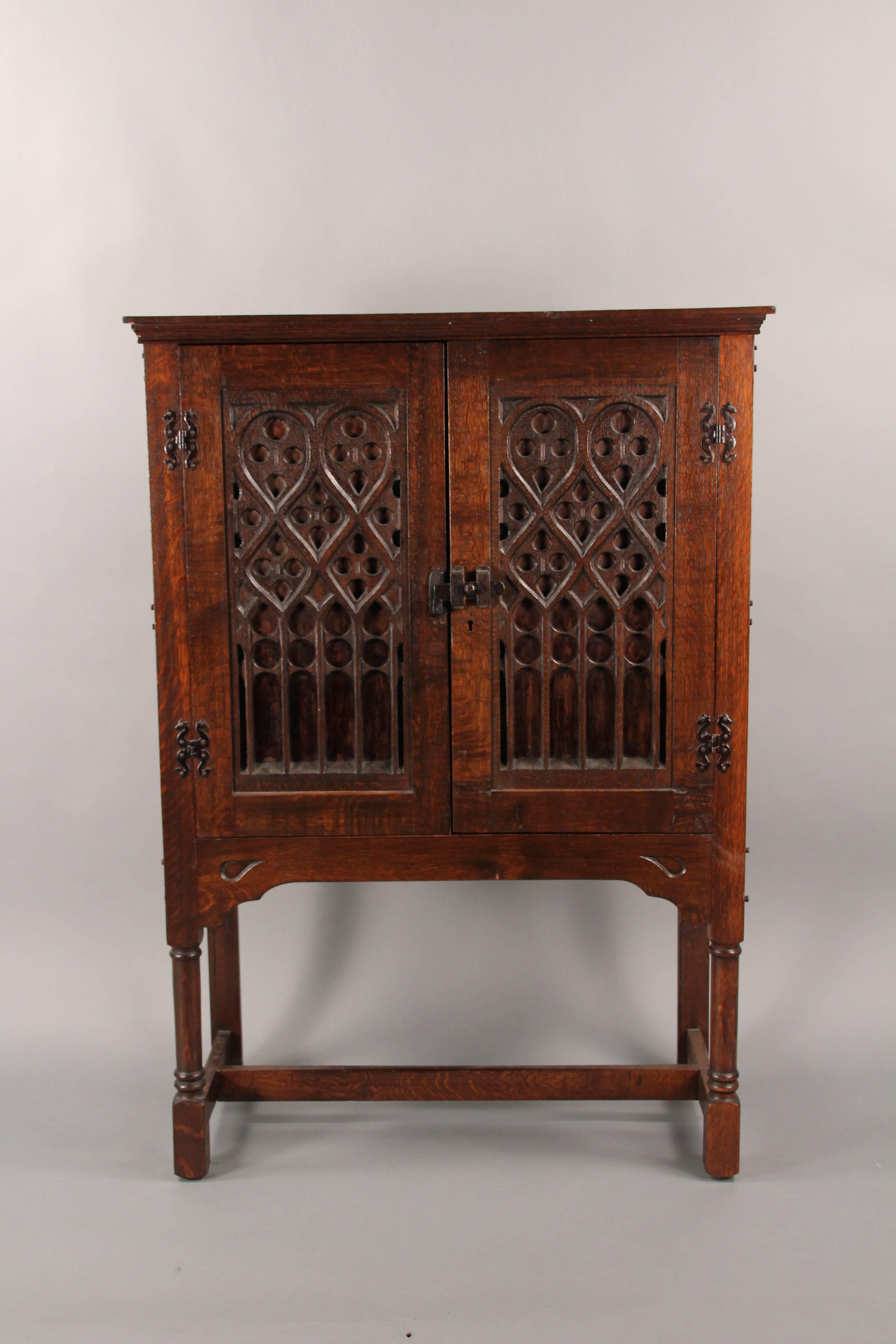 Carved cabinet with two-door and iron hardware, circa 1920s.