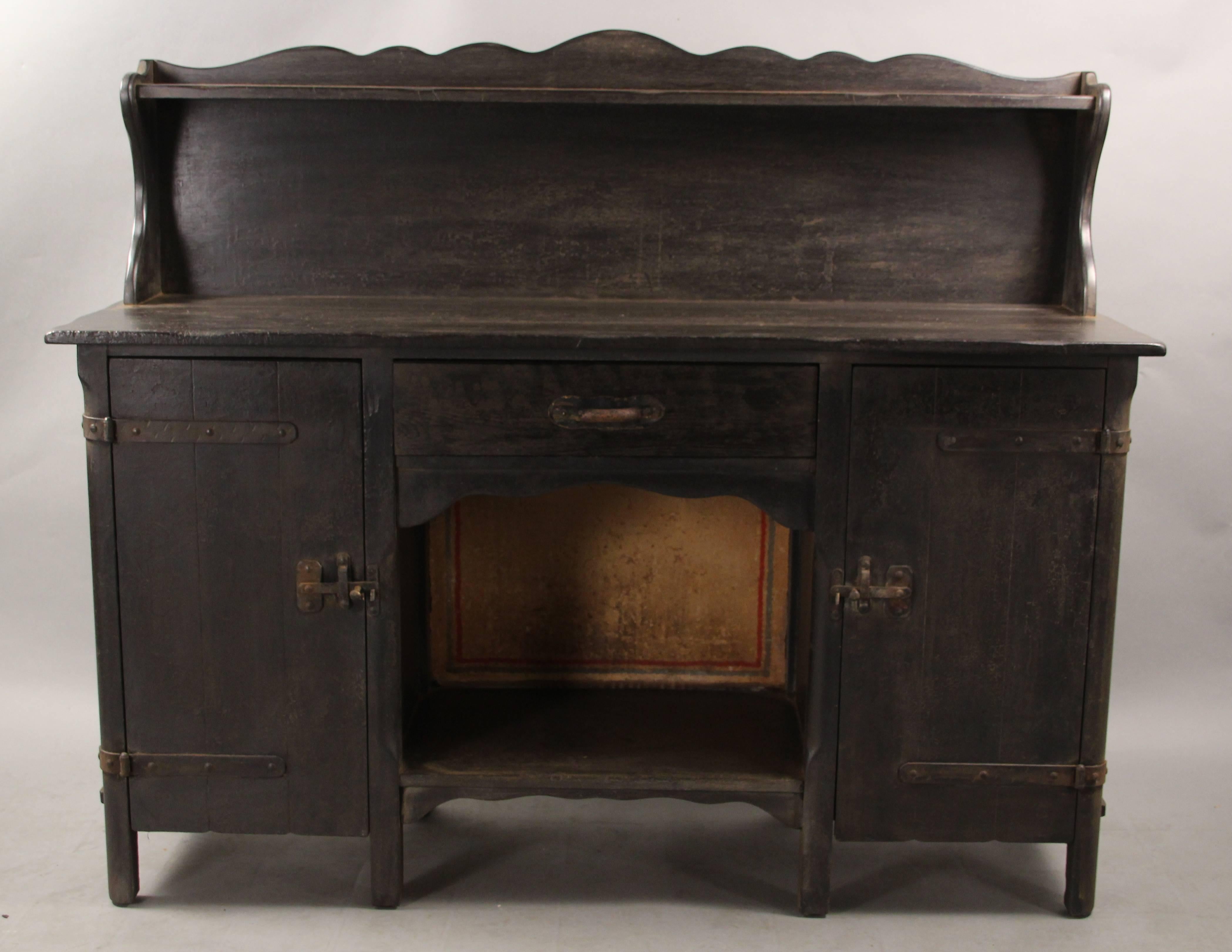 Monterey sideboard with old wood finish. Wonderful iron hardware. It offers a lot of storage area: drawers, cabinet and shelf areas.