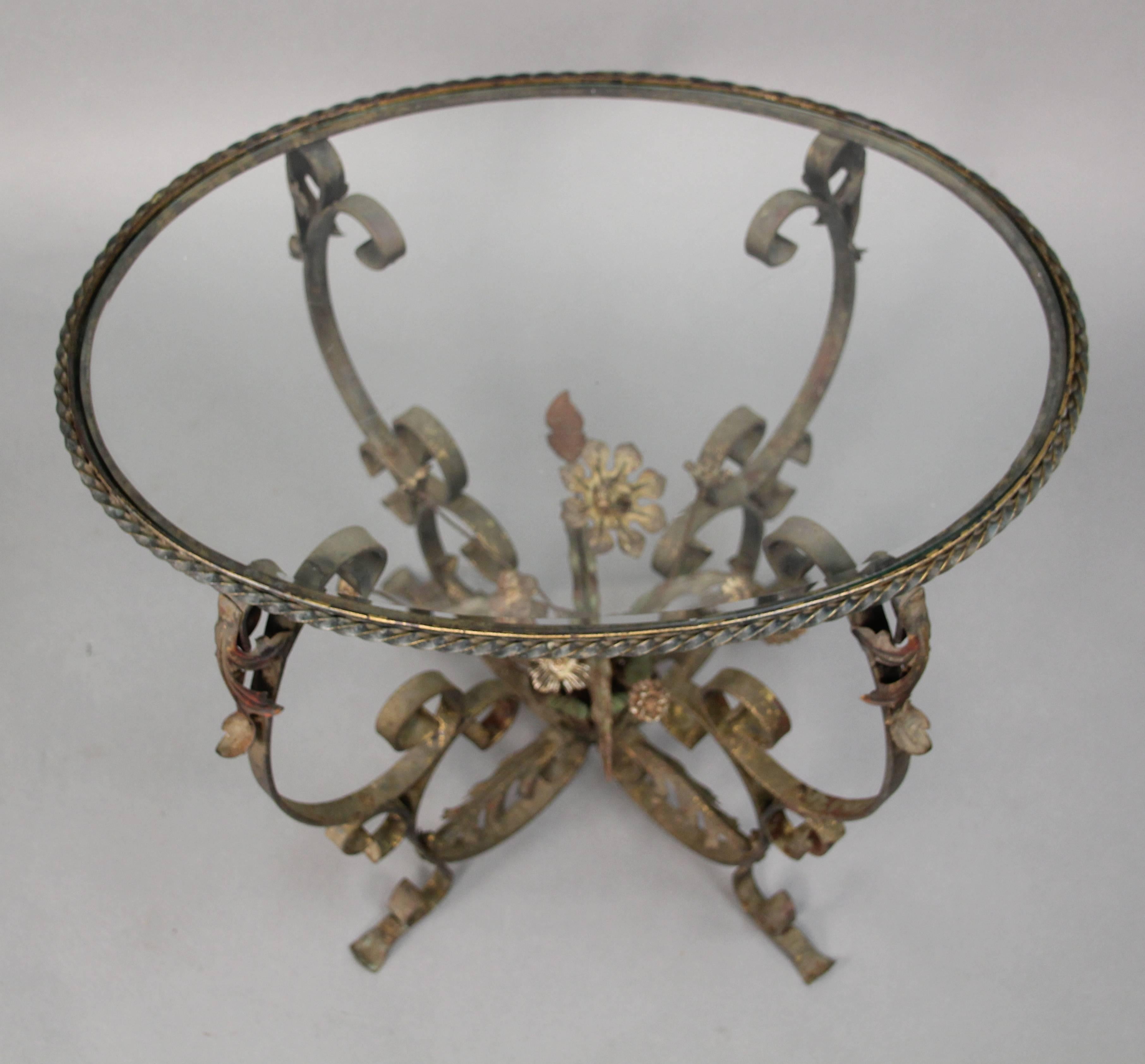 Sweet 1920s glass top side table with floral centrepiece and nice ironwork.