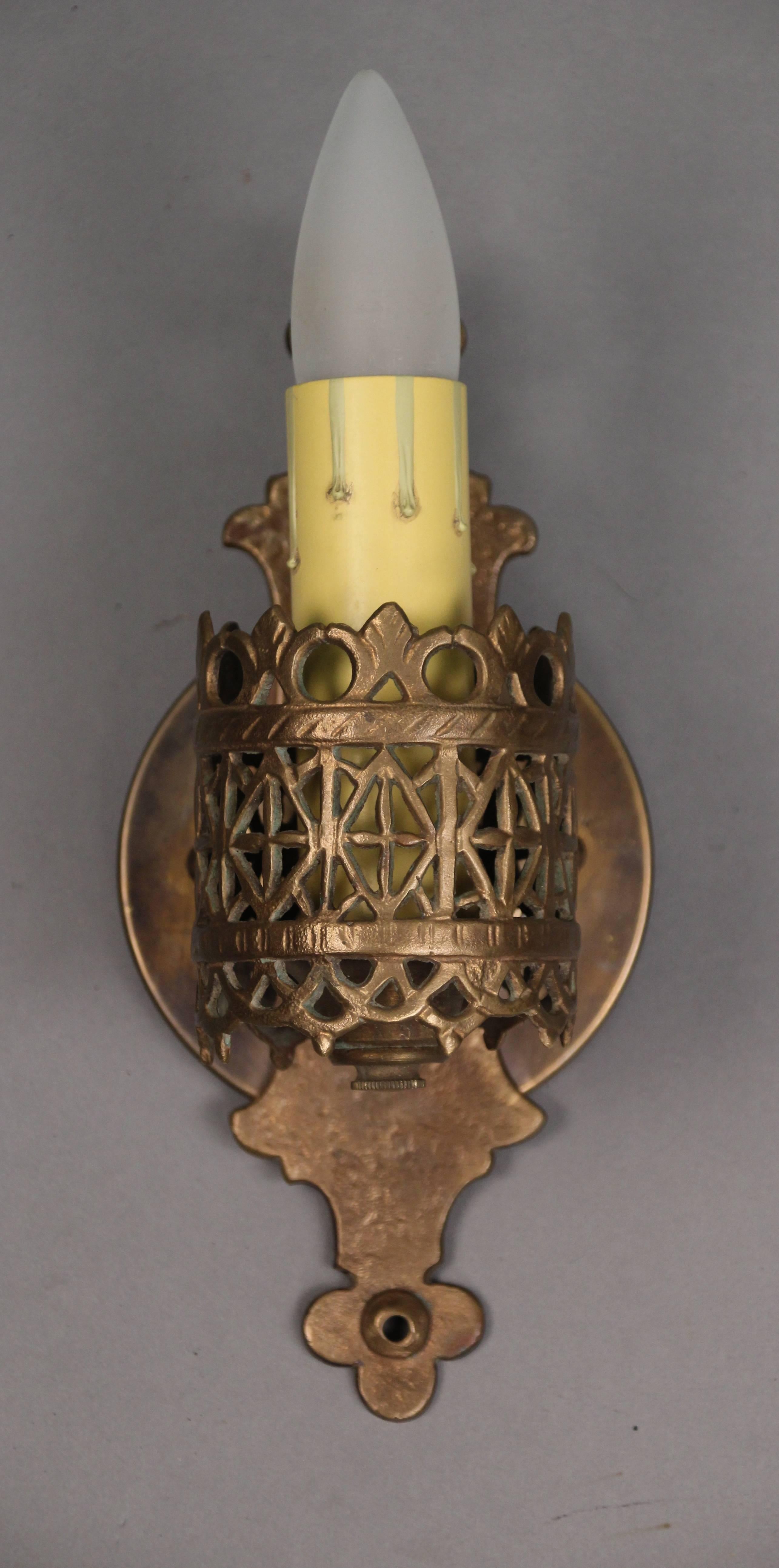 Pair of 20th century bronze signed single sconces made by renown New York metal craftsman Oscar Bach whose work is found at the Metropolitan Museum of Art.