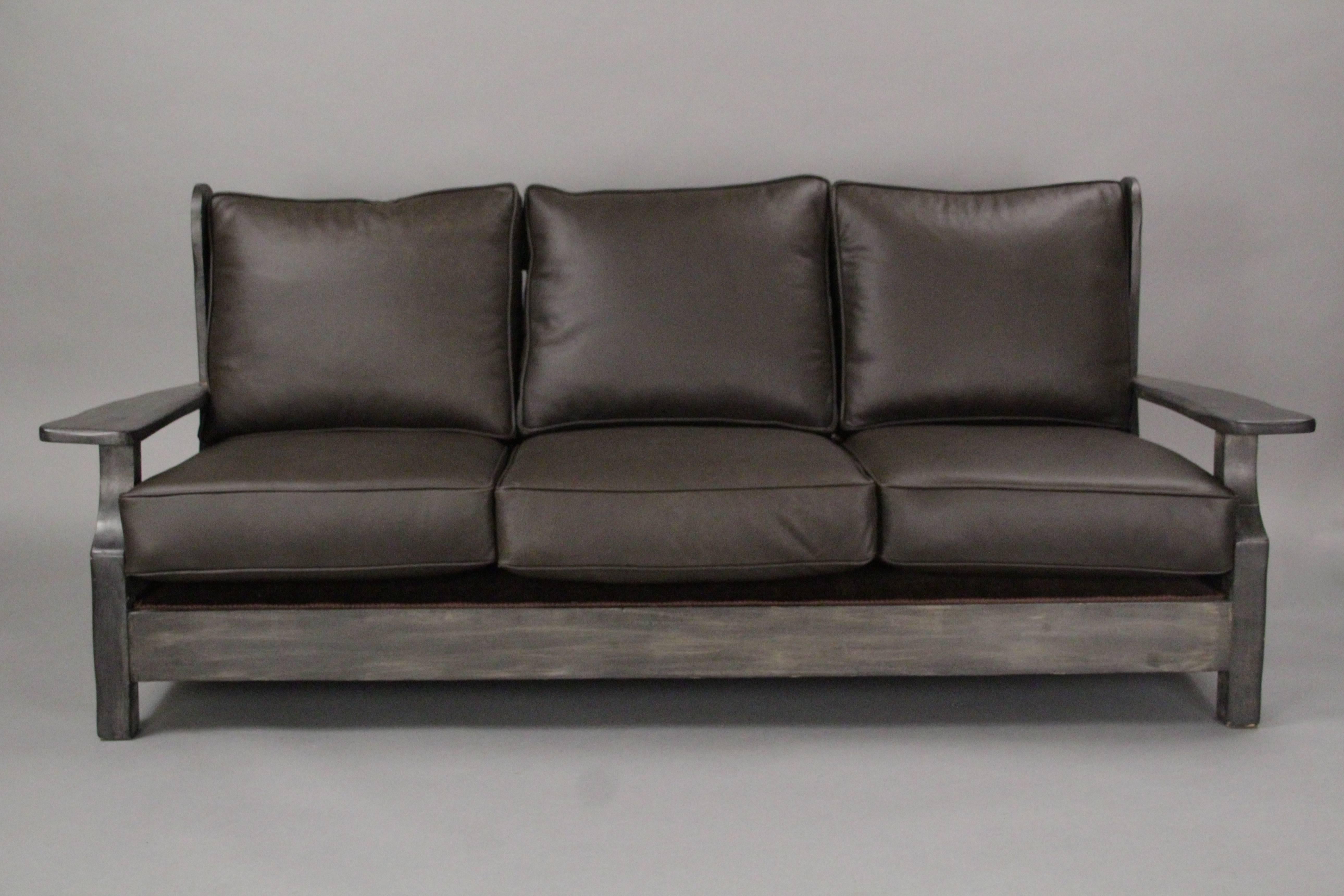 Signed Monterey sofa with new leather upholstery. Restored finish.