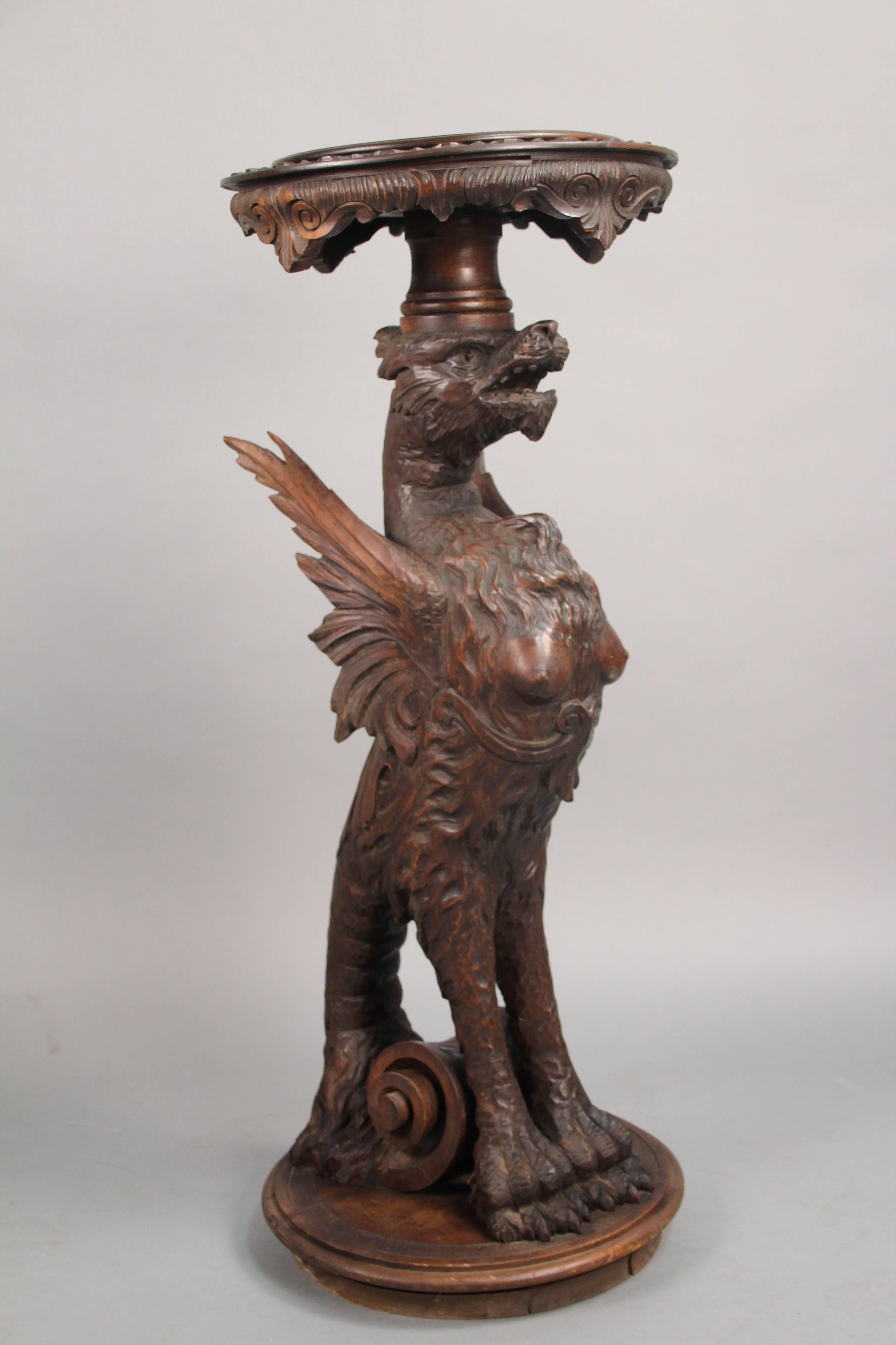 Beautiful carved walnut stand with outstanding detailed carving featuring a griffin. Measures: 35.25