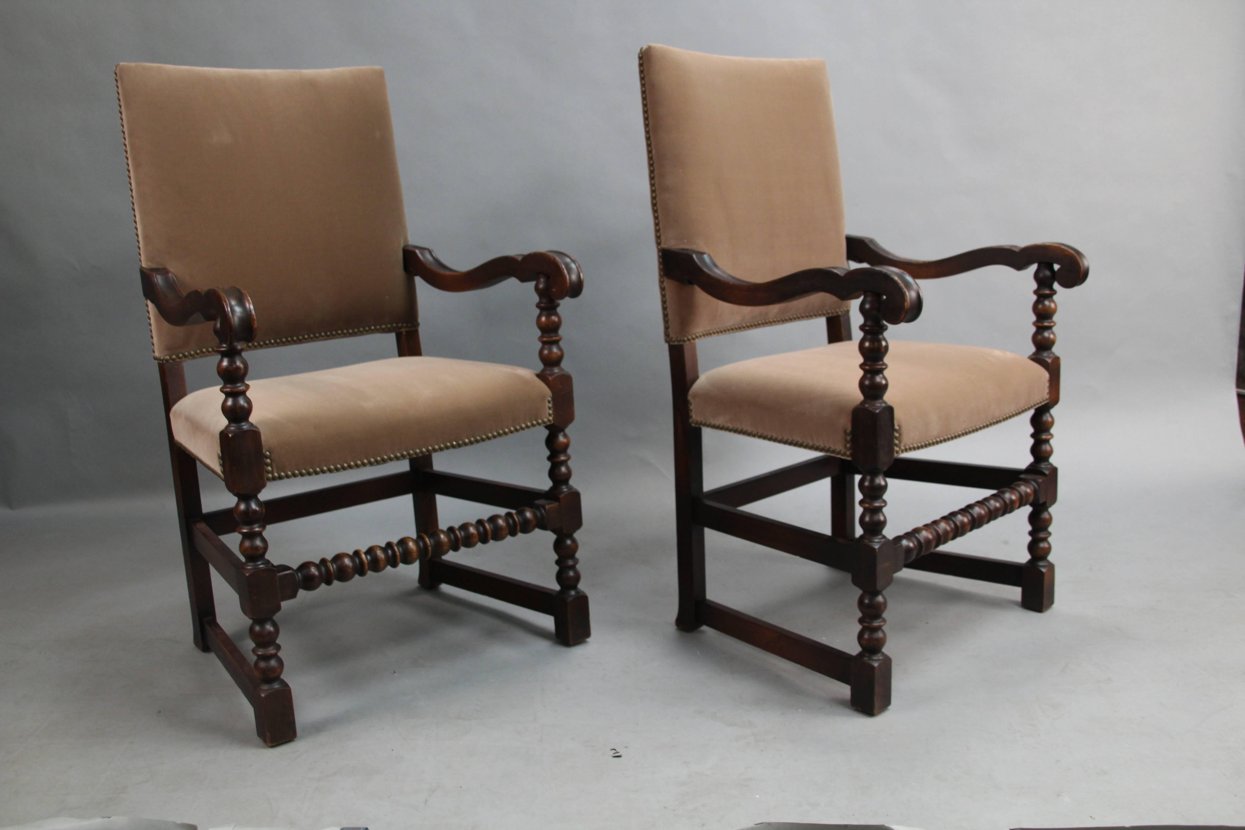 Classic 1920s pair of armchairs with new Belgian velvet upholstery. Carved walnut frames. Measures: 41.5