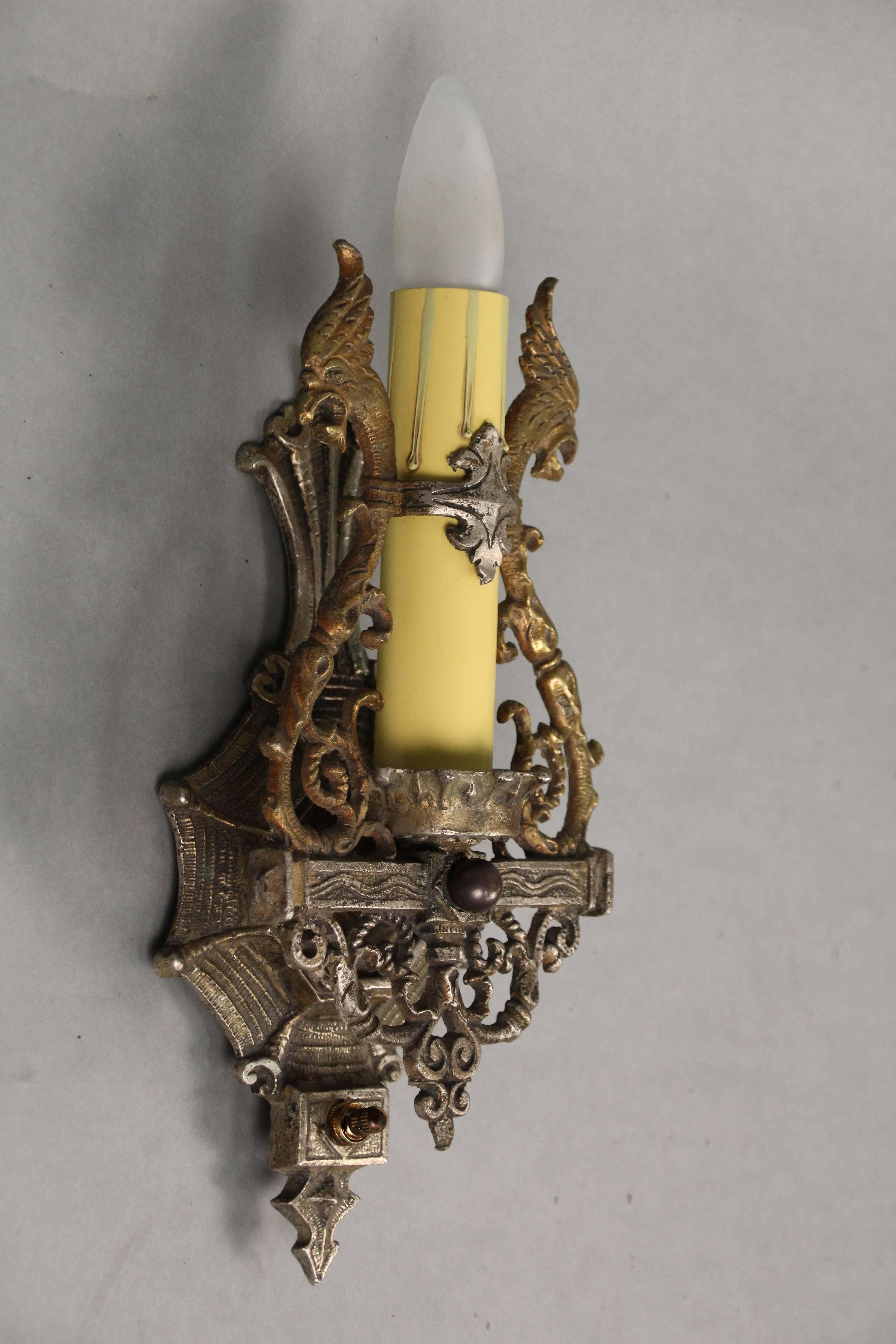 Two-toned single sconce with original finish. Would fit nicely in Spanish Revival or English Tudor home.