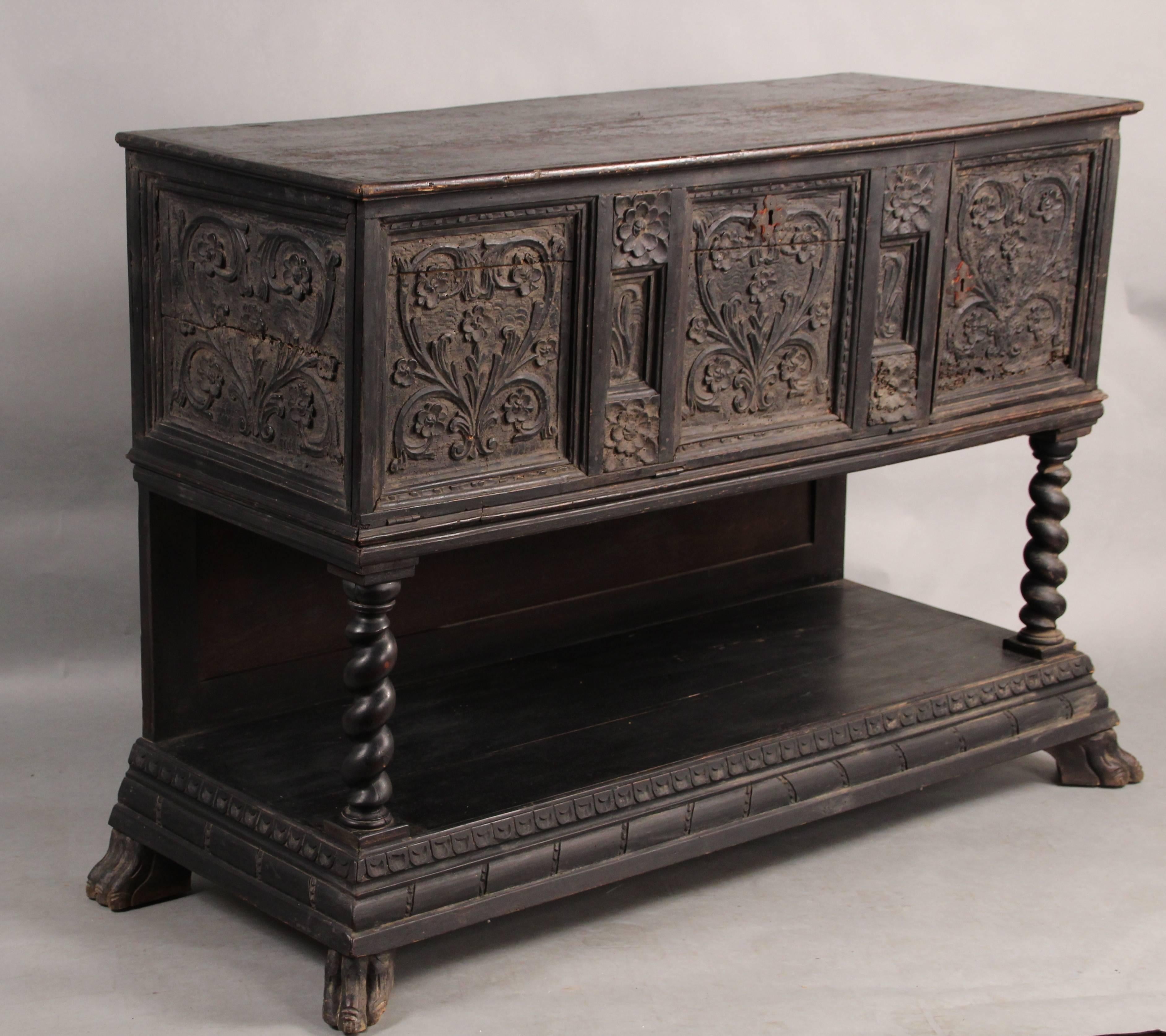 Very early sideboard with hand-carved details. The piece shows wear normal considering the age of the piece.