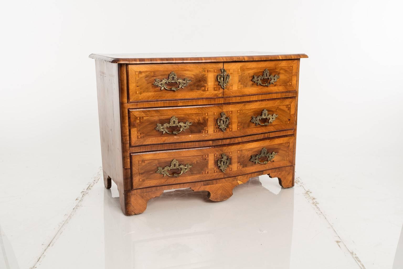 Three drawer walnut chest with a serpentine front and burl walnut inlay.