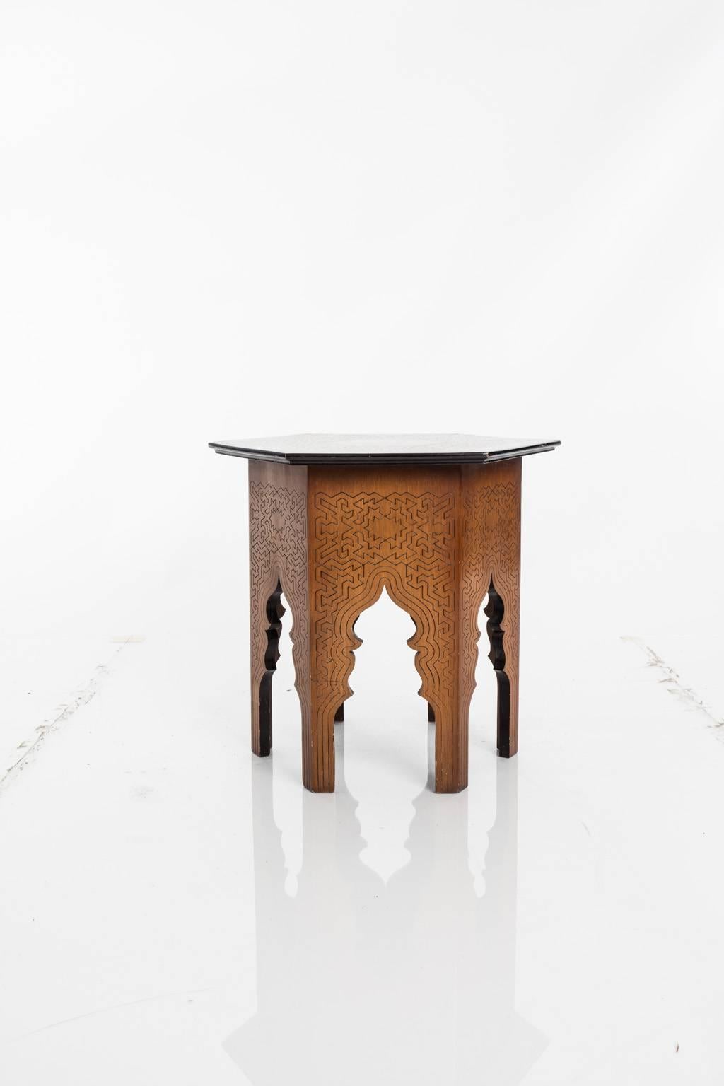 Hexagonal side table with geometric pattern motif throughout.