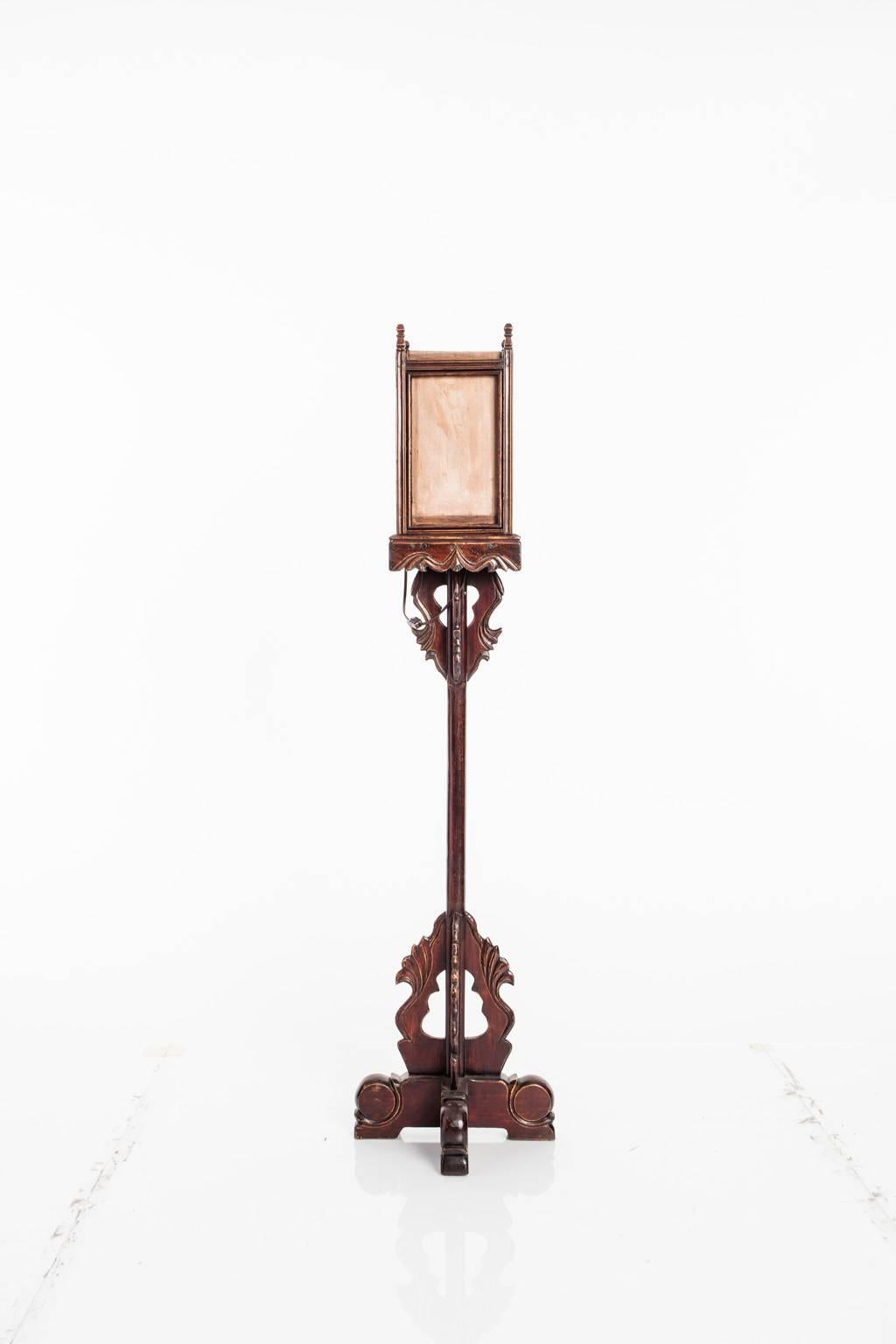Early 20th century Chinese lantern set on a carved rosewood tripod stand.