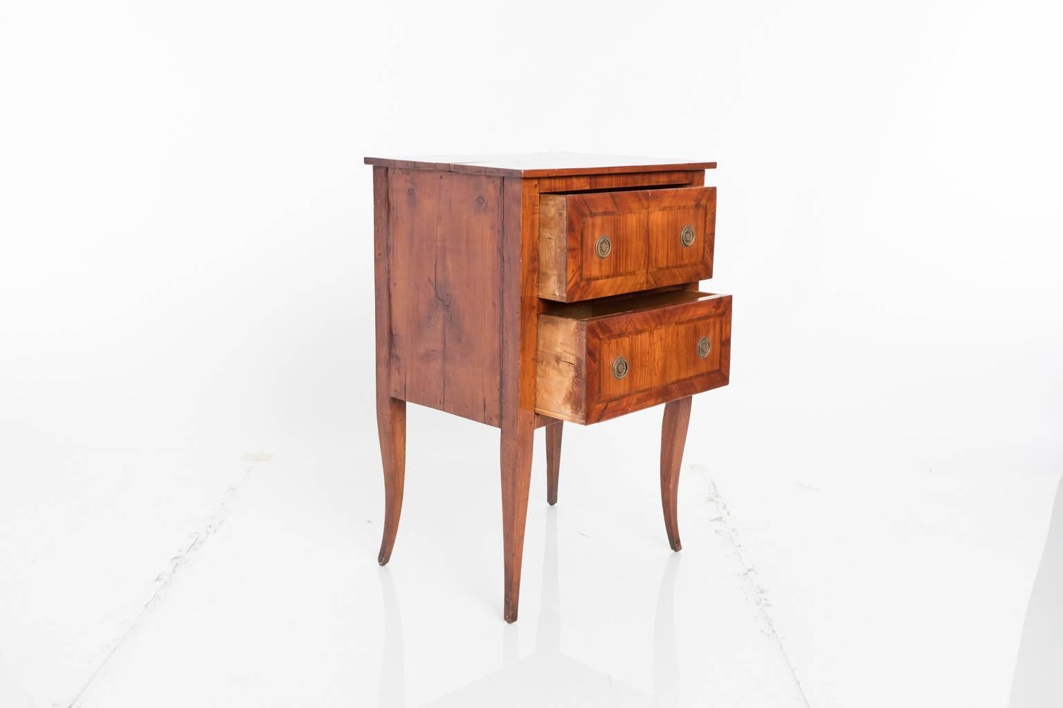 Directoire style, small two-drawer cabinet with inlay decorated drawers, and brass hardware.