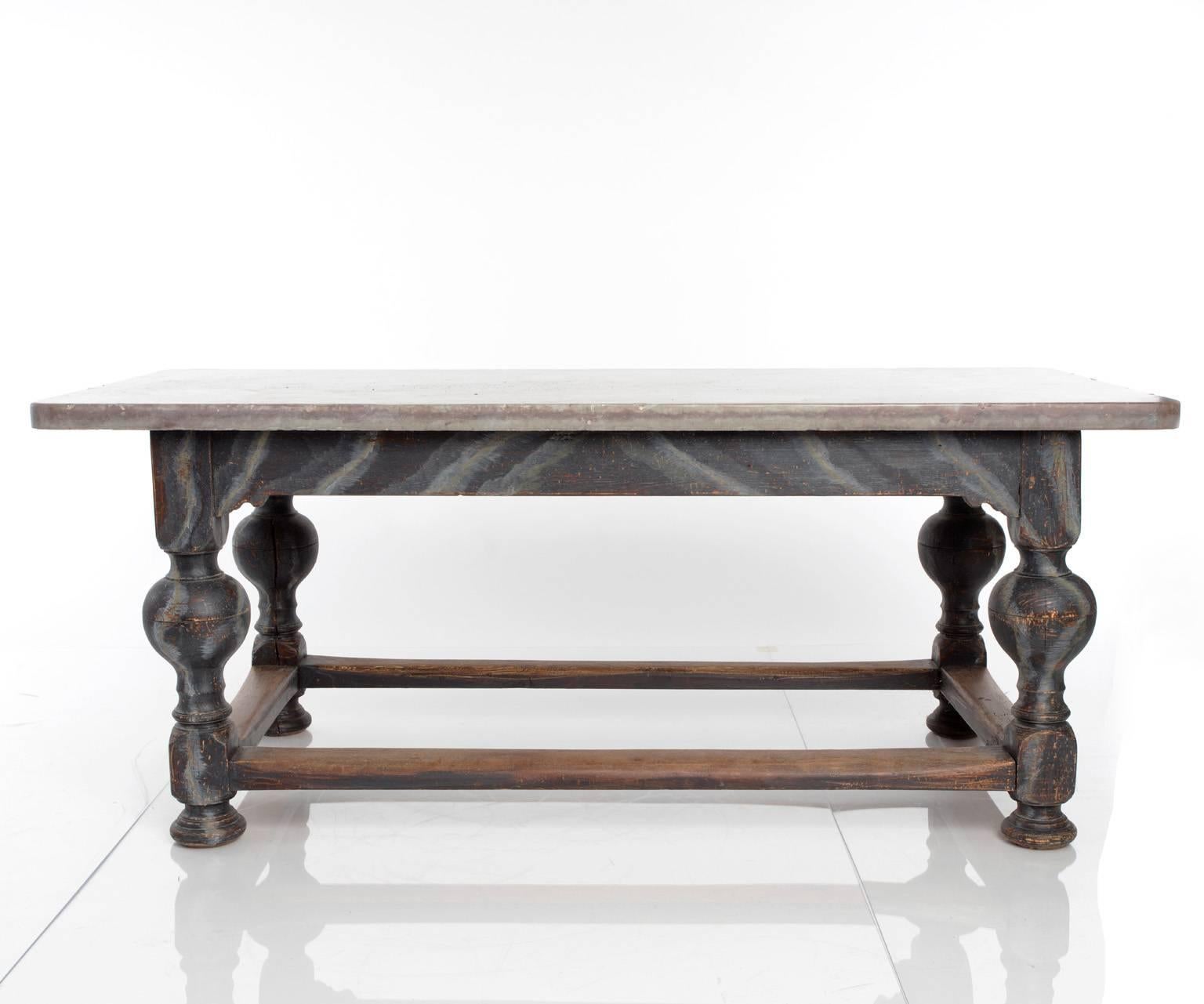Swedish, late 18th early 19th century. A large oak table with painted grey marbling and oland stone top. Straight skirt, turned legs on ball foot, stretchers.
 