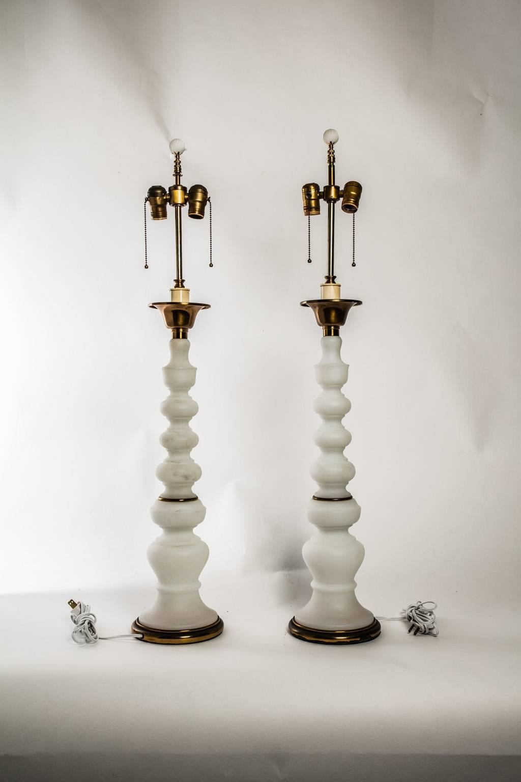 Pair of milk glass column lamps with gold banding at throughout.