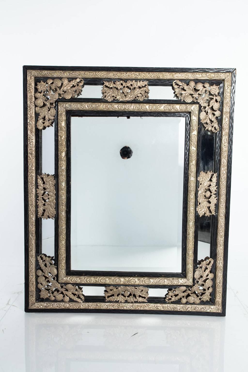 19th century Dutch mirror with wonderful nickel over brass repoussage details.
