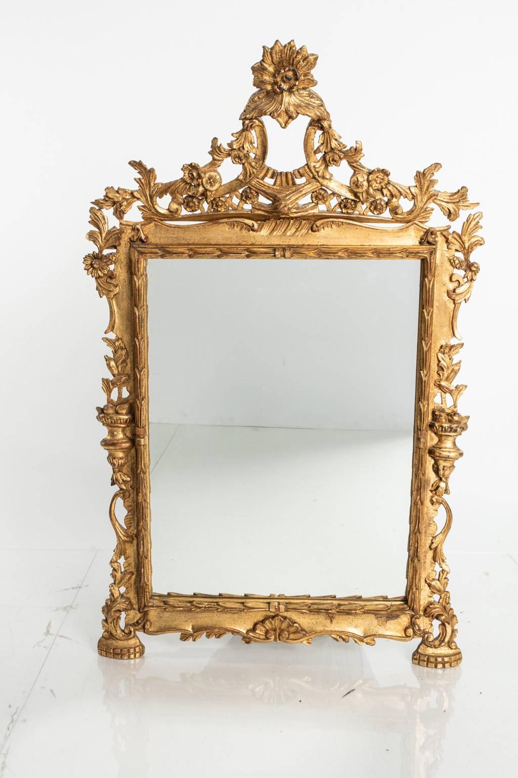 Italian mirror, ornately carved and gilded.