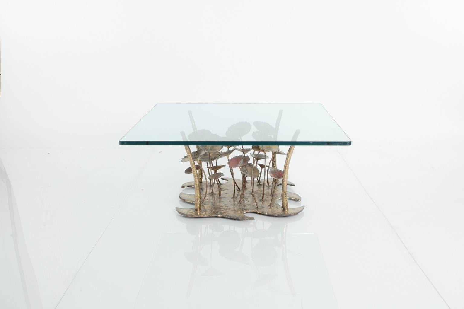 Signed Silas Seandel sculptural coffee table. The mixed metal base is topped with glass.