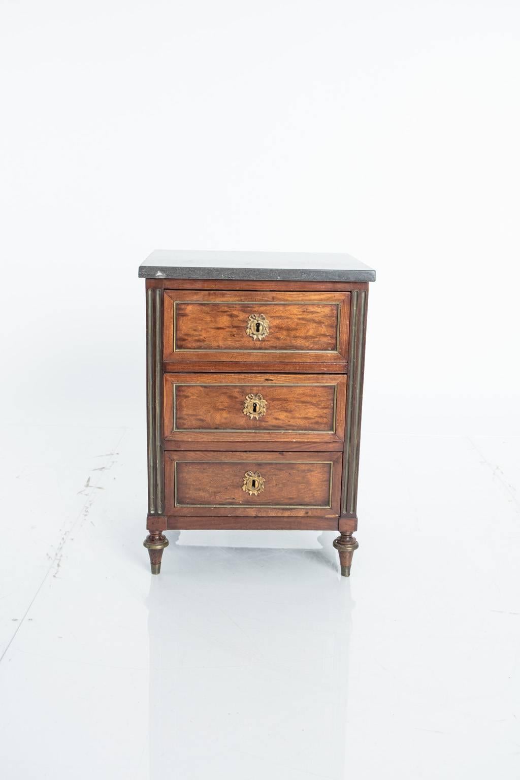 French three-drawer, fruitwood commode with bronze drawer surrounds.