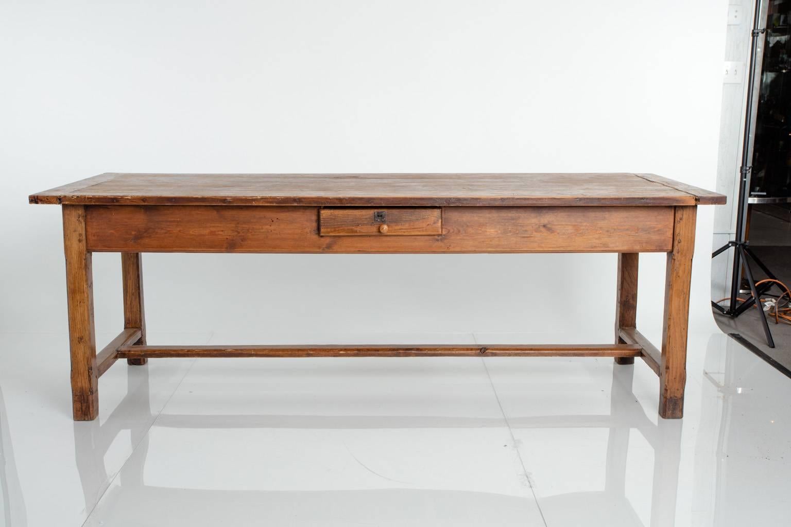 Early 19th century, French pine farm table. Three drawers. Breadboard ends.