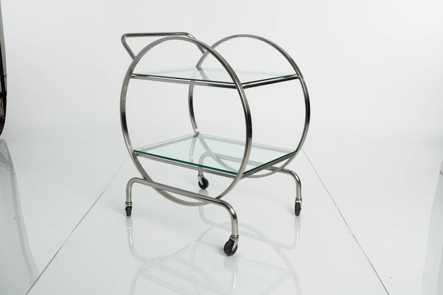 Steel and glass rolling tea cart with two glass shelves.