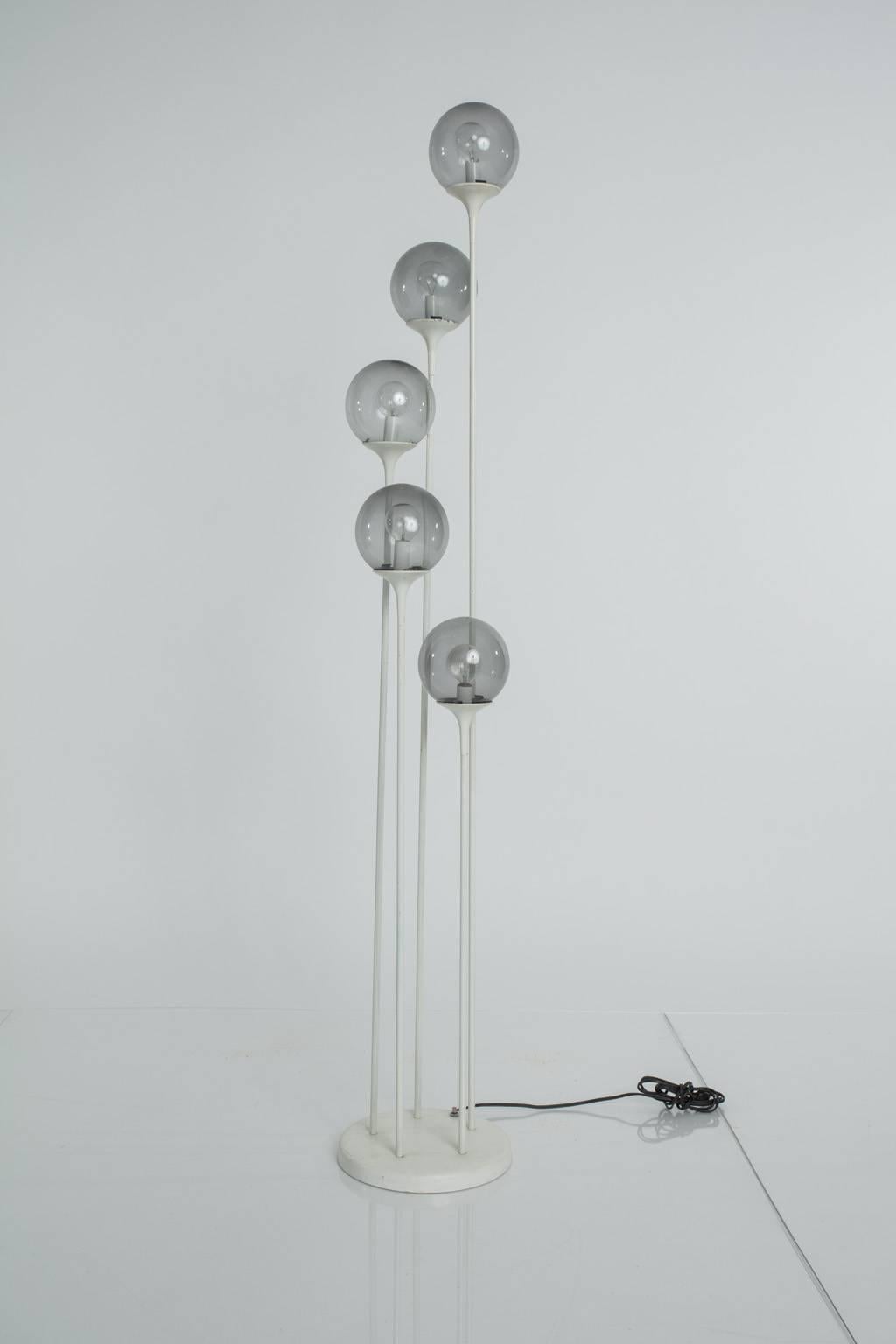 Five-light floor lamp with smoked glass globes.