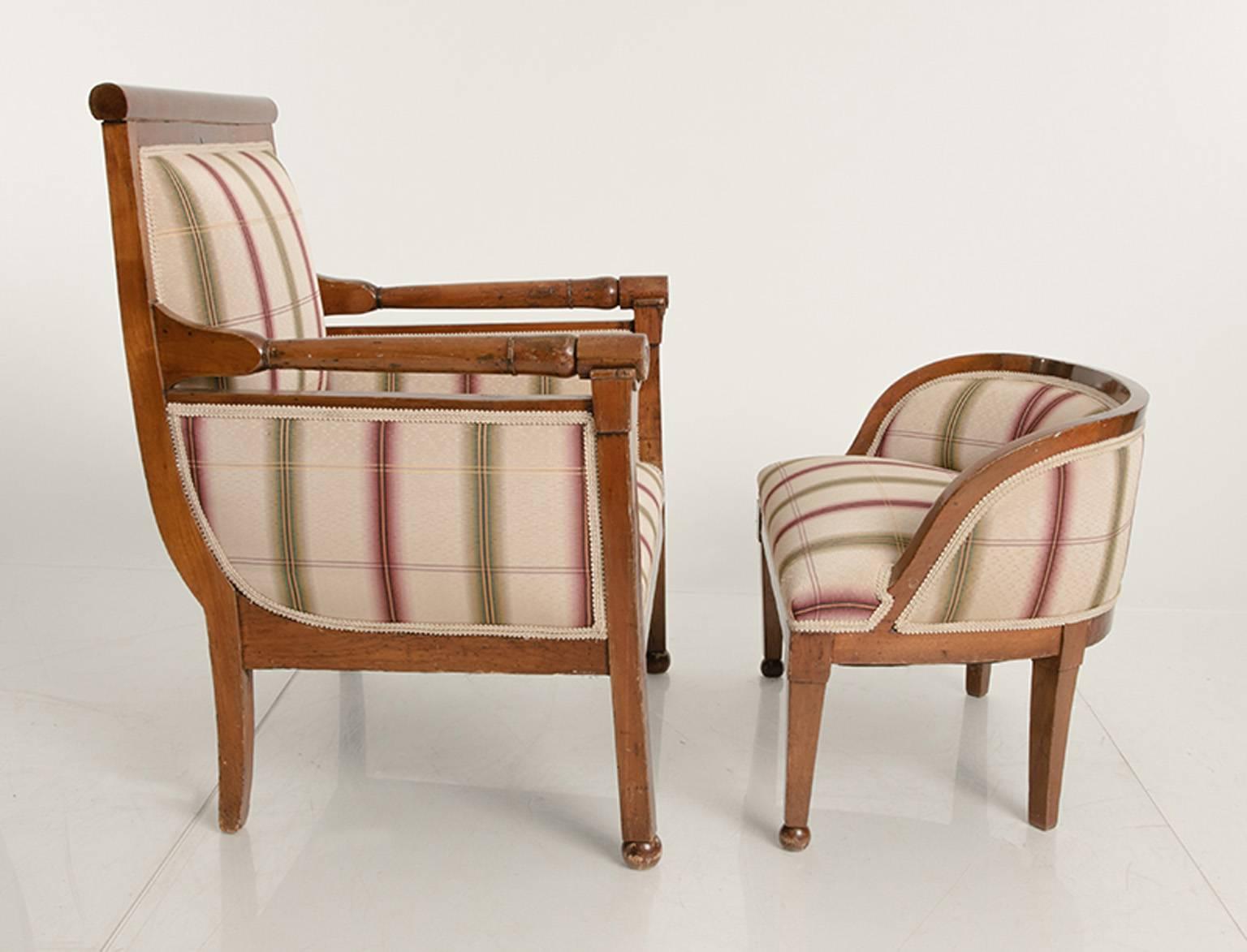 Two part Biedermeier chair and ottoman in a walnut frame.