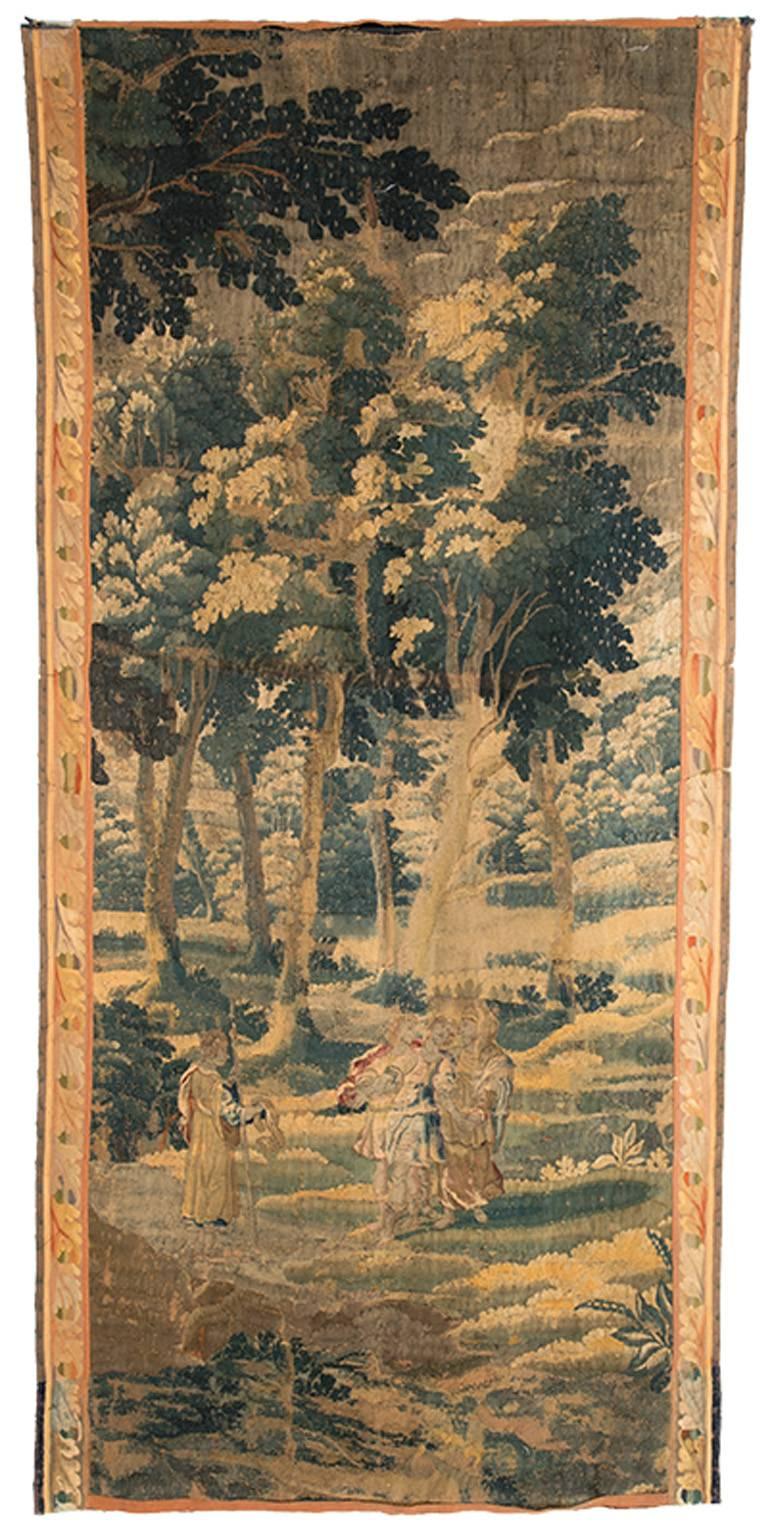 18th century, Flemish tapestry depicting a vertical garden landscape. A forest and river are represented in tones of blue, beige, green, and brown.