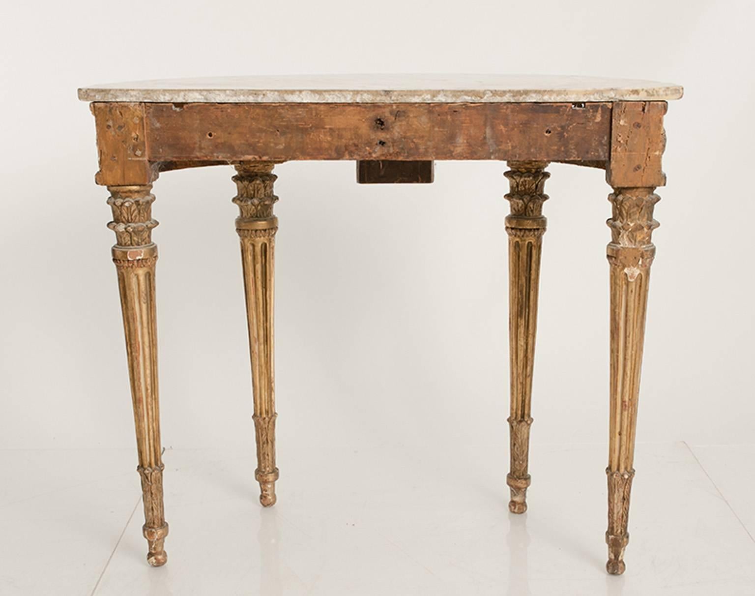 Early 18th century Italian demilune console with marble top and distressed gilding.