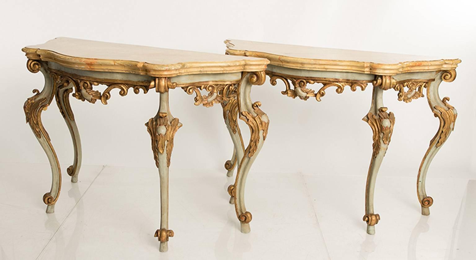 Pair of 19th century faux painted and gilded Venetian consoles. The apron and legs are curved and carved.
