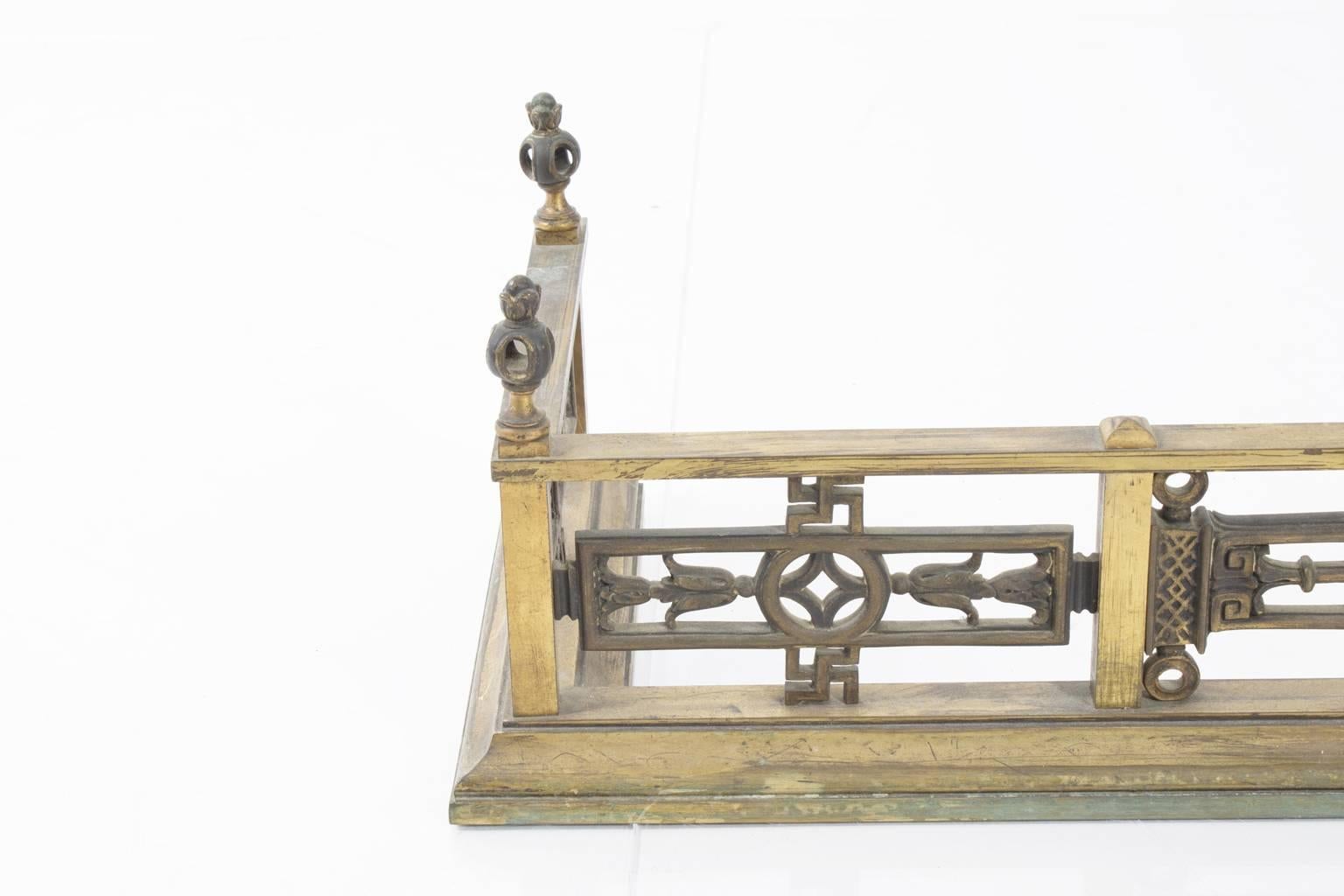 Bronze and iron chinoiserie style fireplace fender and andiron.
 