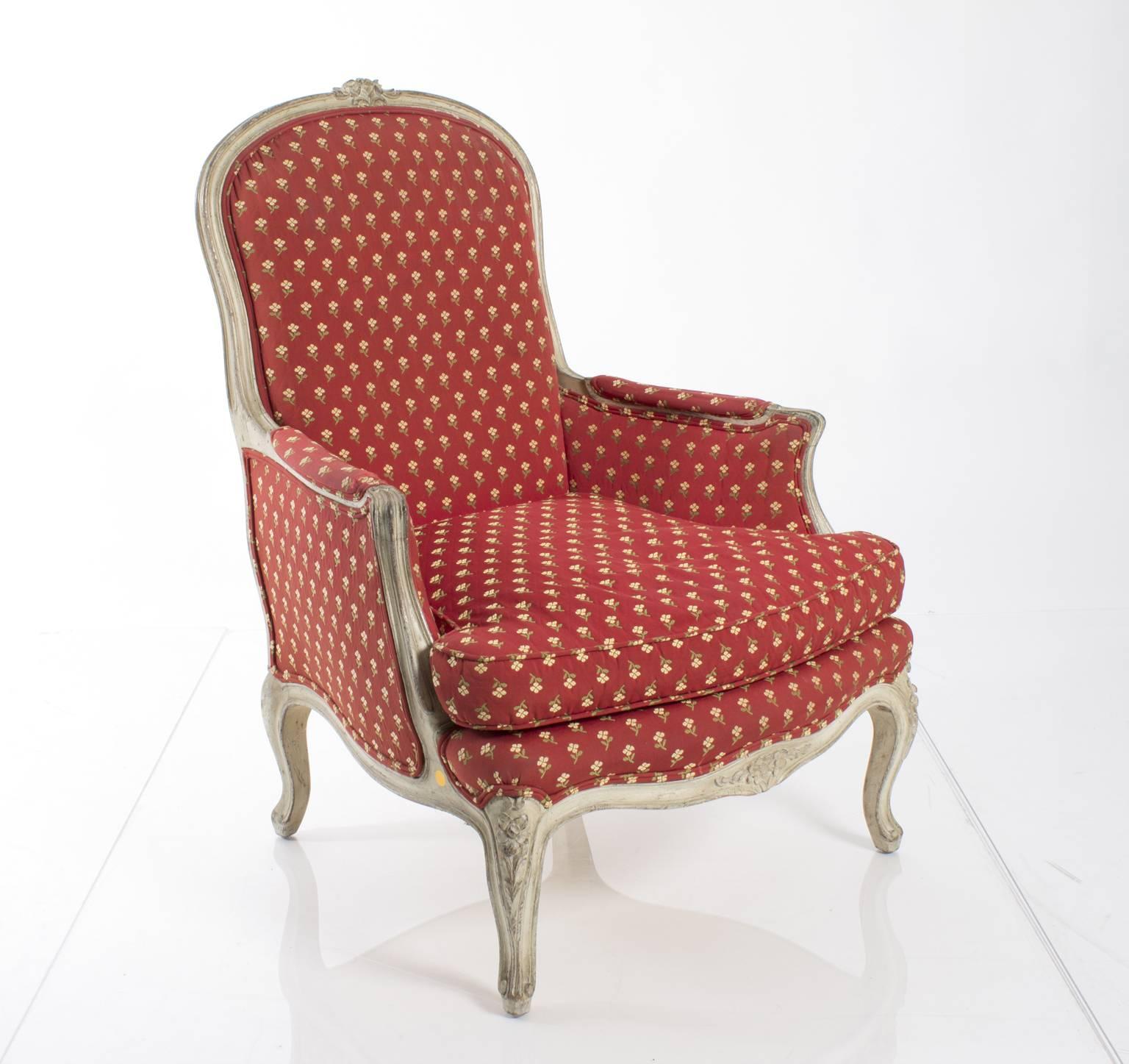 Pair of French bergères upholstered in a red and yellow floral print fabric.
   