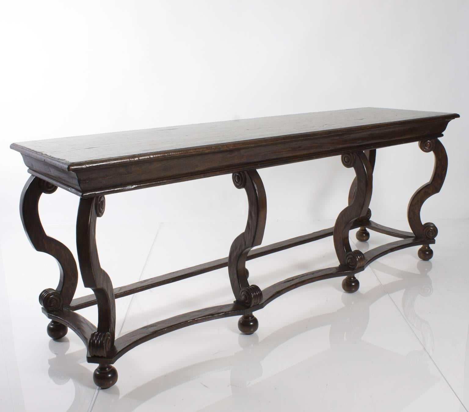 Oak console table with eight cabriole style legs. Maker: Collections Reproductions.
   