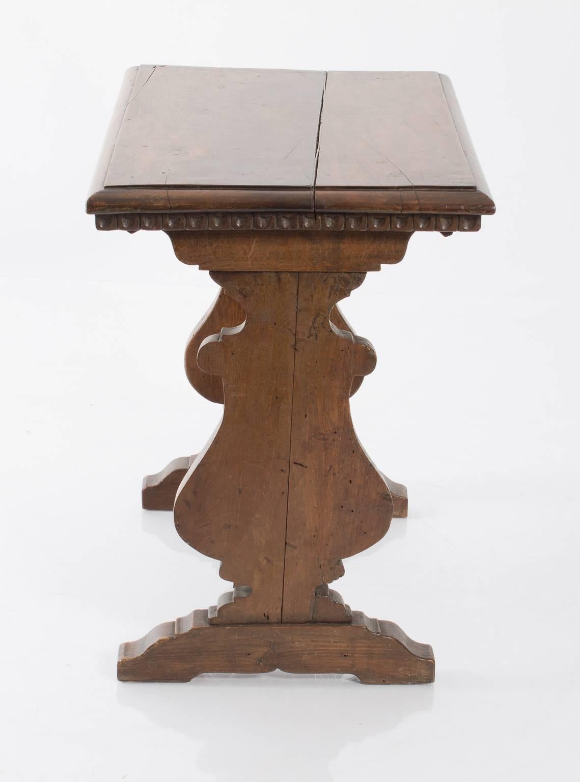 19th century Italian walnut side table with decorative stretcher.