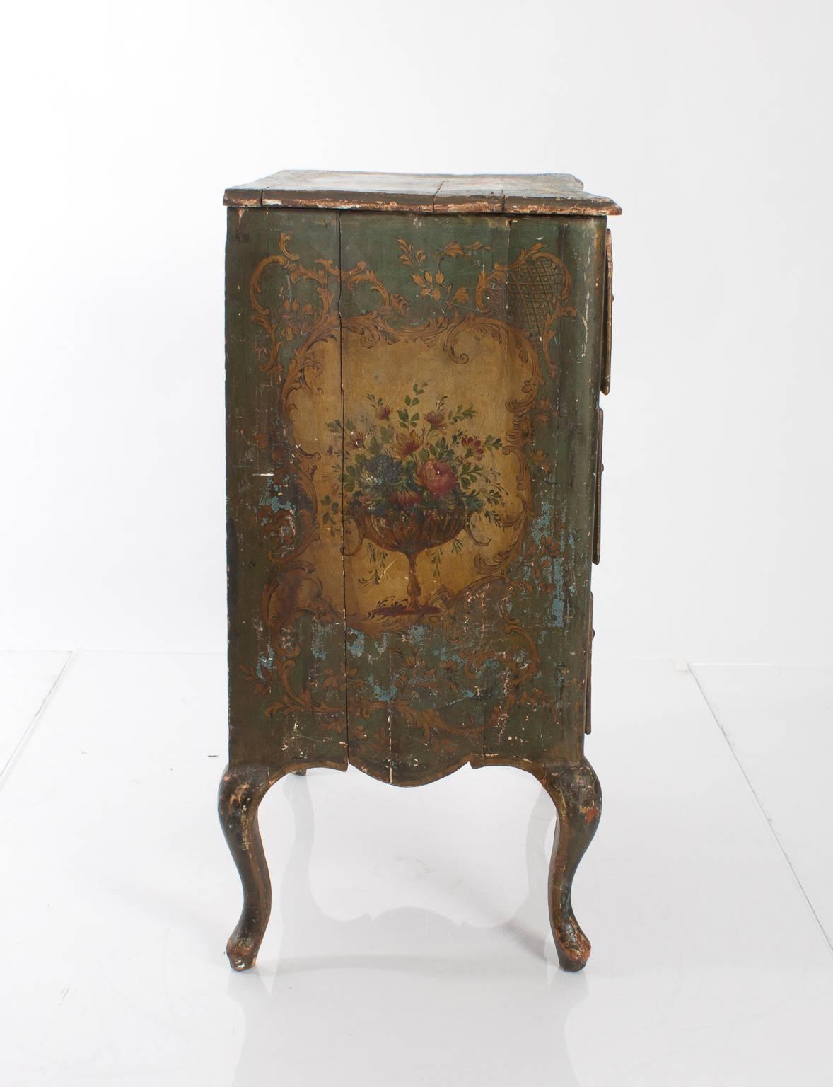 Early 19th century, painted Venetian three-drawer commode with cabriole legs. Floral hand-painted sidepanels and drawers.
