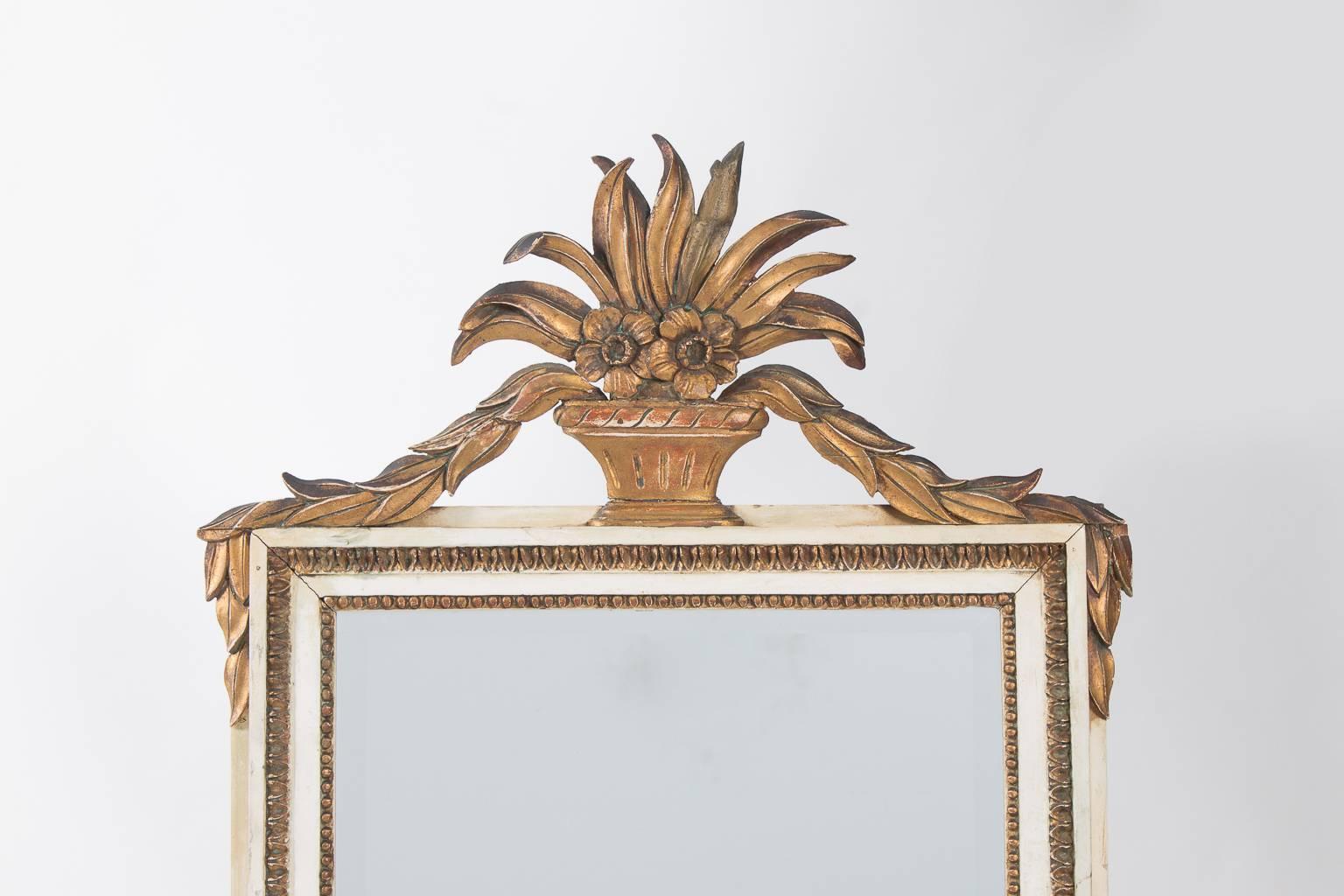 Early 20th century, Louis XVI style, French mirror. Gilded and painted with carved decorative elements. (Repair on the back of the 