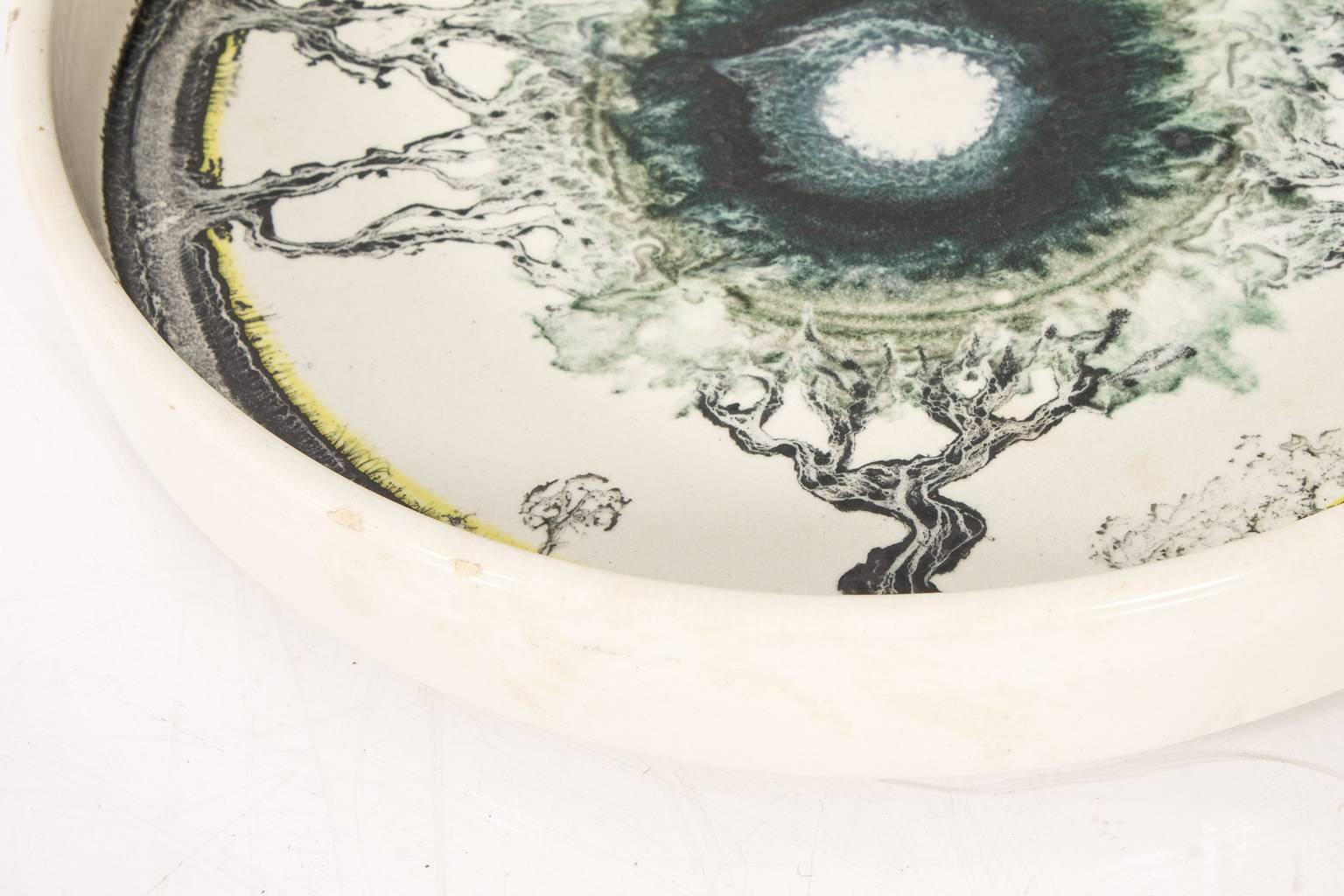 Mid-Century style ceramic bowl with an abstract painted interior.