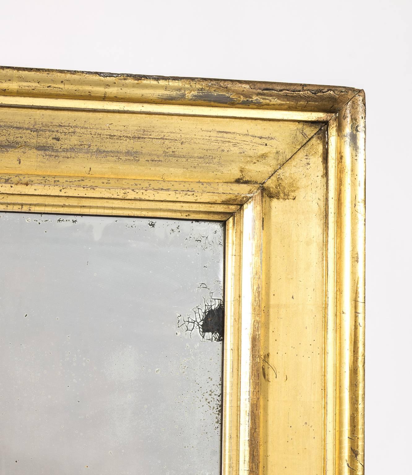 19th century beveled mirror in large gilt frame.