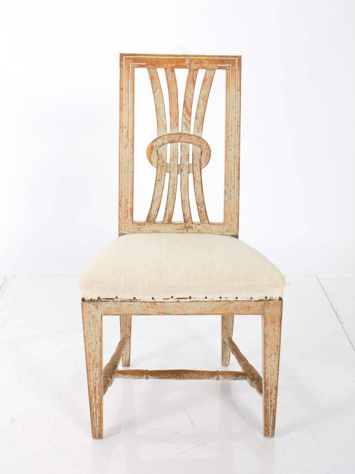 Early 19th century pair of white-painted late Gustavian chairs with open back work.