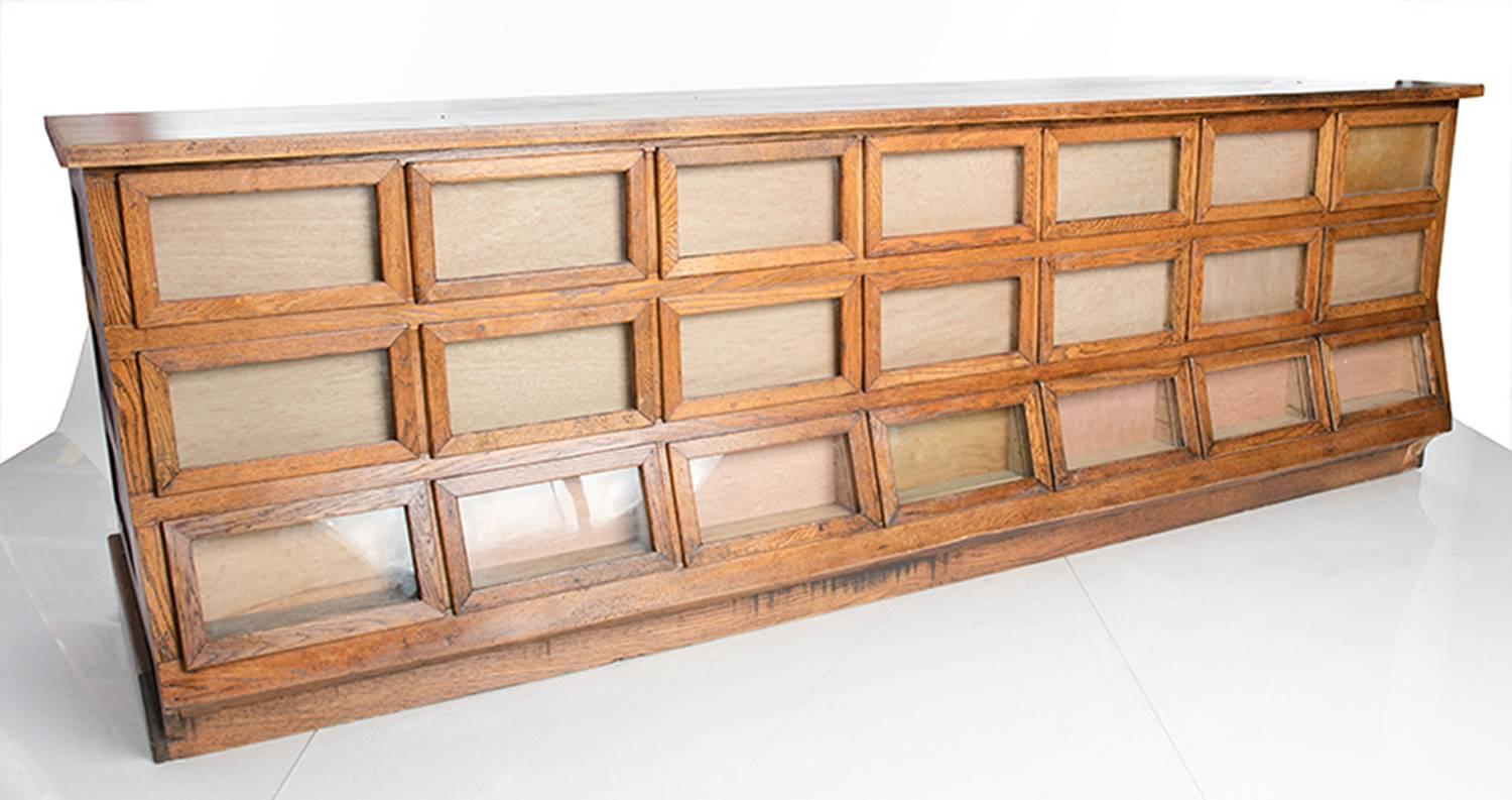 Antique Maryland general store oak seed display counter. 21 drawers with original cashier drawer. View-able from all sides.