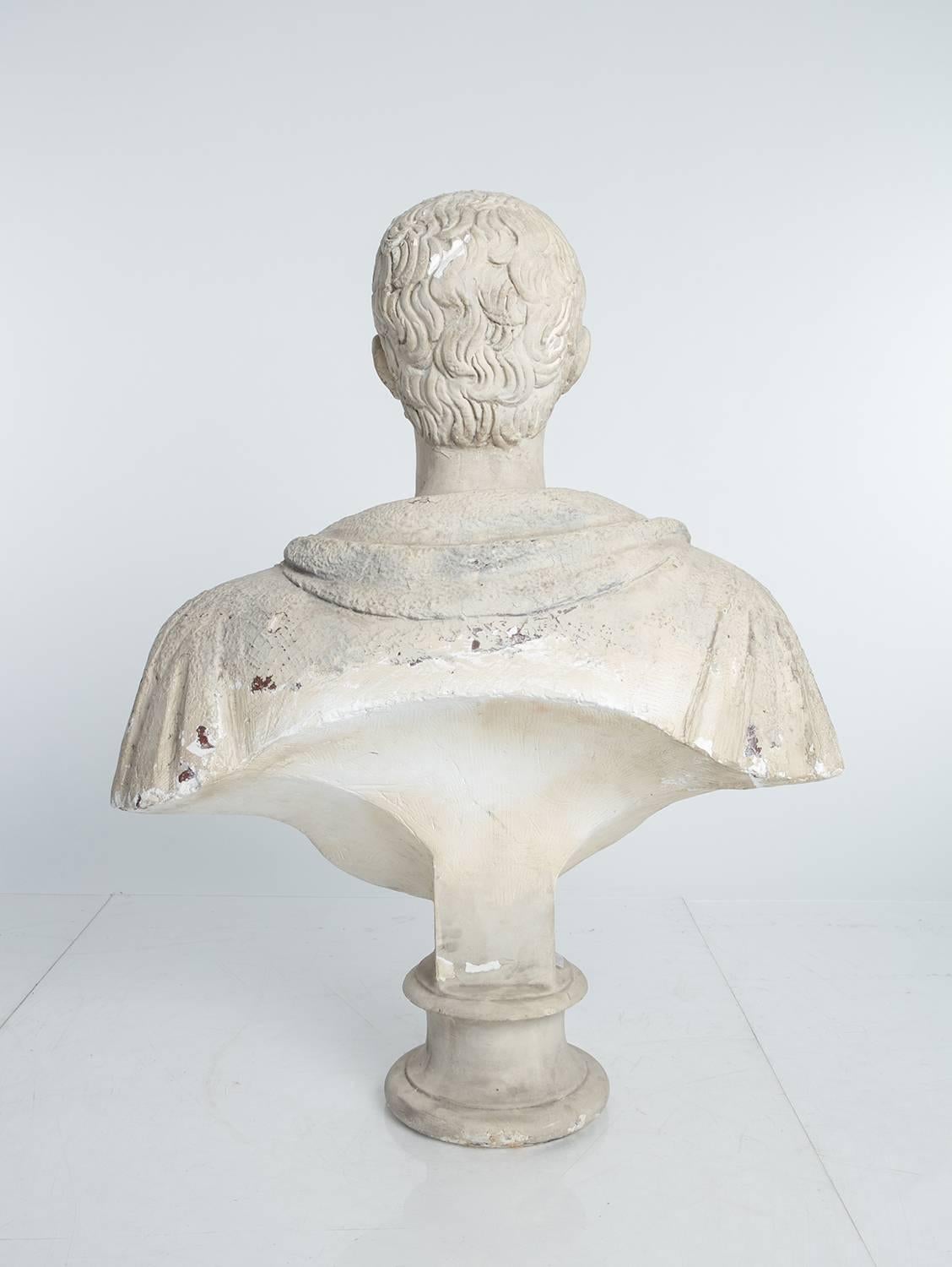 Plaster portrait bust of a Roman Patrician. Neoclassical in feeling and likely used in a theatrical set.