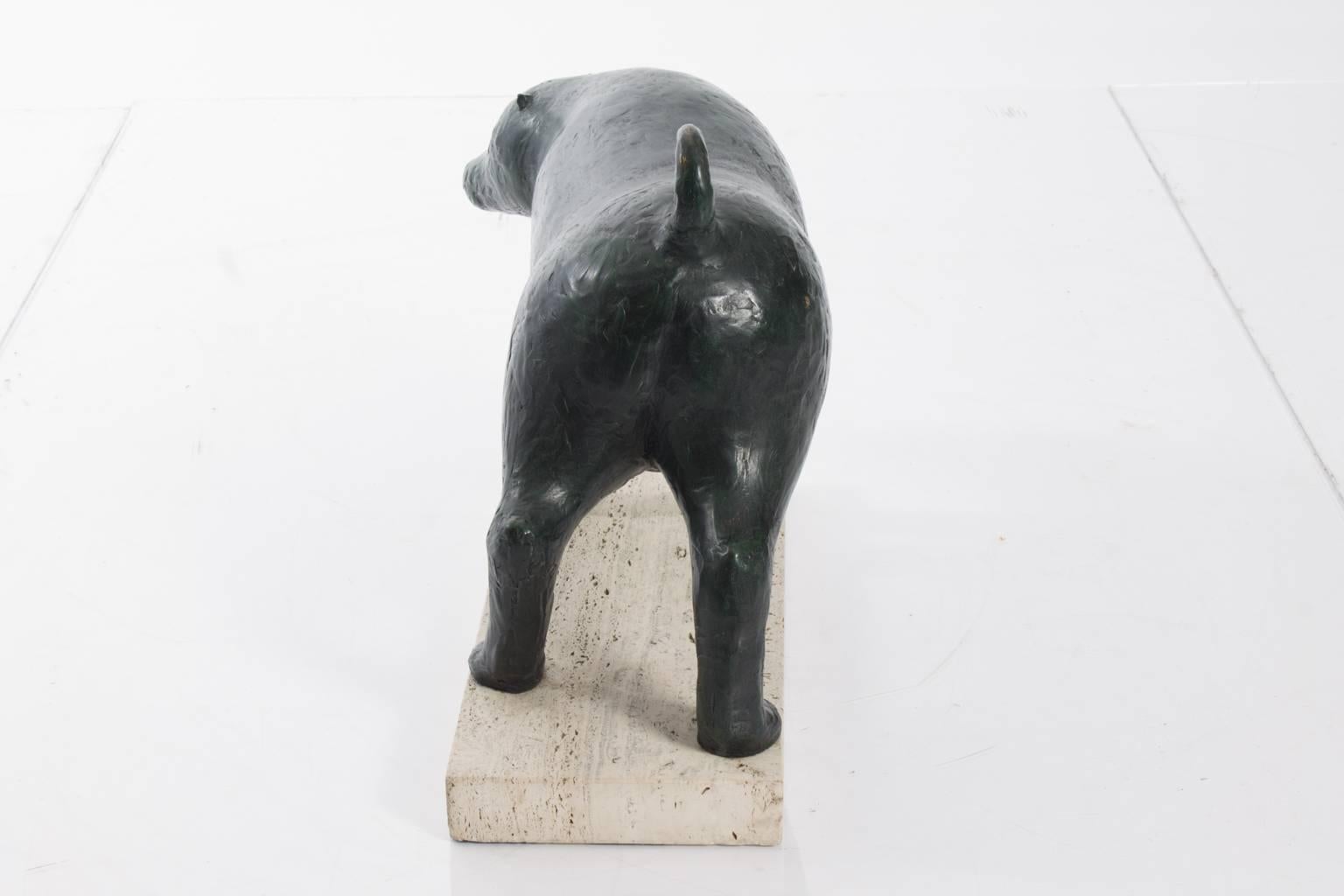 Bronze statue of an animal on limestone base. Signed, 