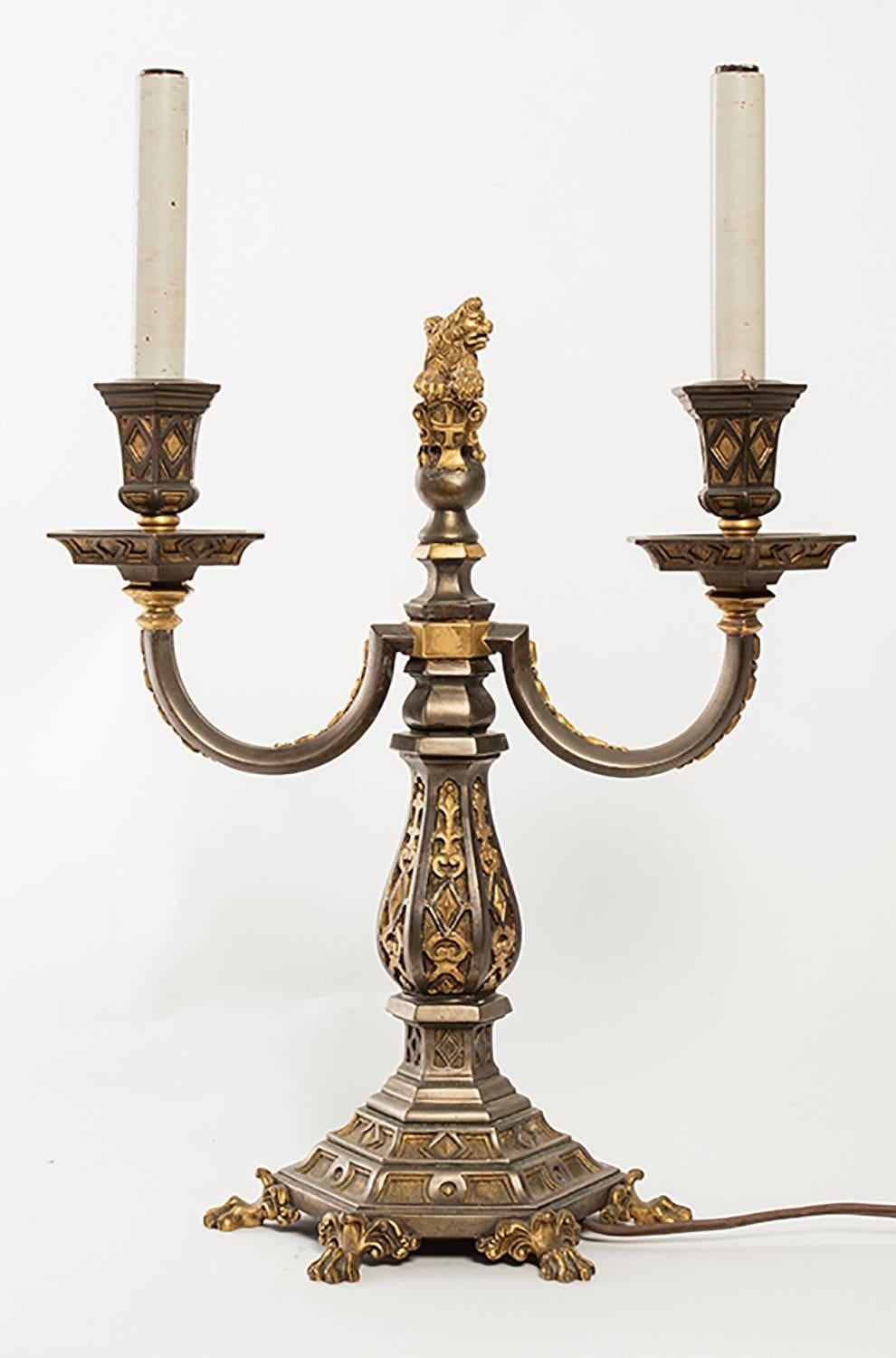Pair of Caldwell quality candelabra lamps with ornate lion finials.