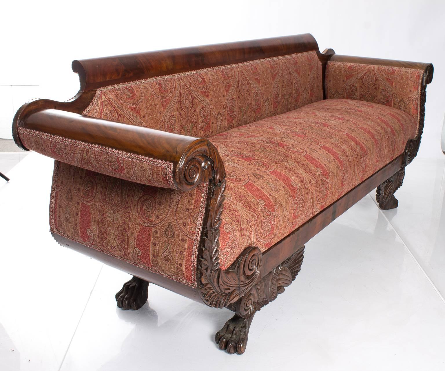 Burl walnut settee with rolled arms and carved apron on claw feet. Paisley fabric.