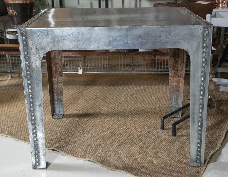 Superb English polished steel water tank table with studding to top edges and legs.

Dealer item # 040-12